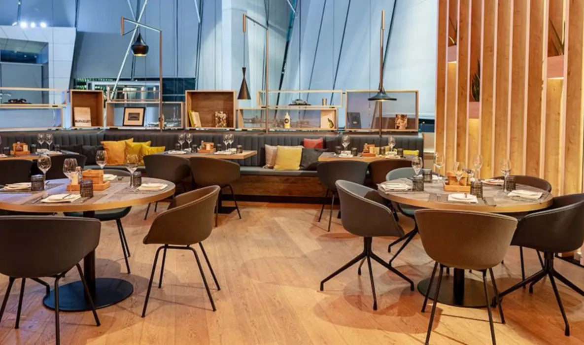 interior view of the bavarie in the bmw welt with a cozy ambience due to wood and warm materials.