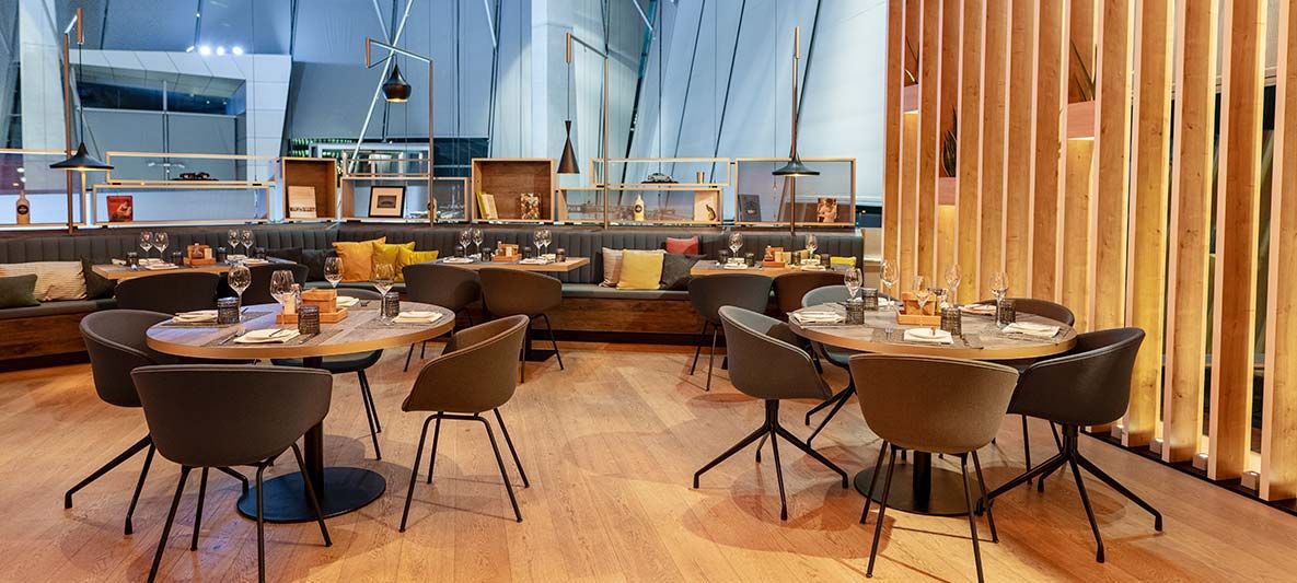 interior view of the bavarie in the bmw welt with a cozy ambience due to wood and warm materials.