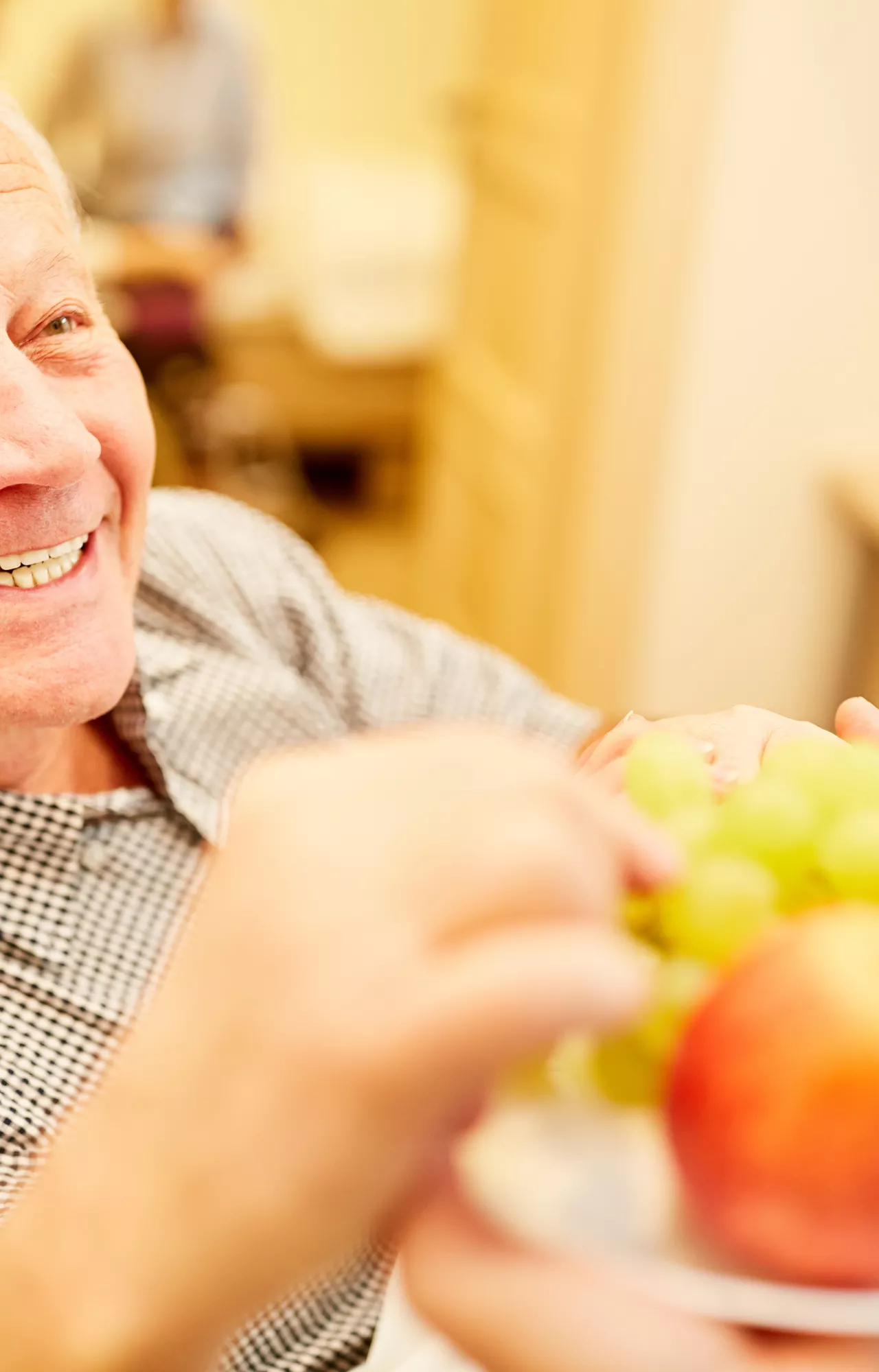 Älterer Herr bekommt einen Teller mit Äpfeln