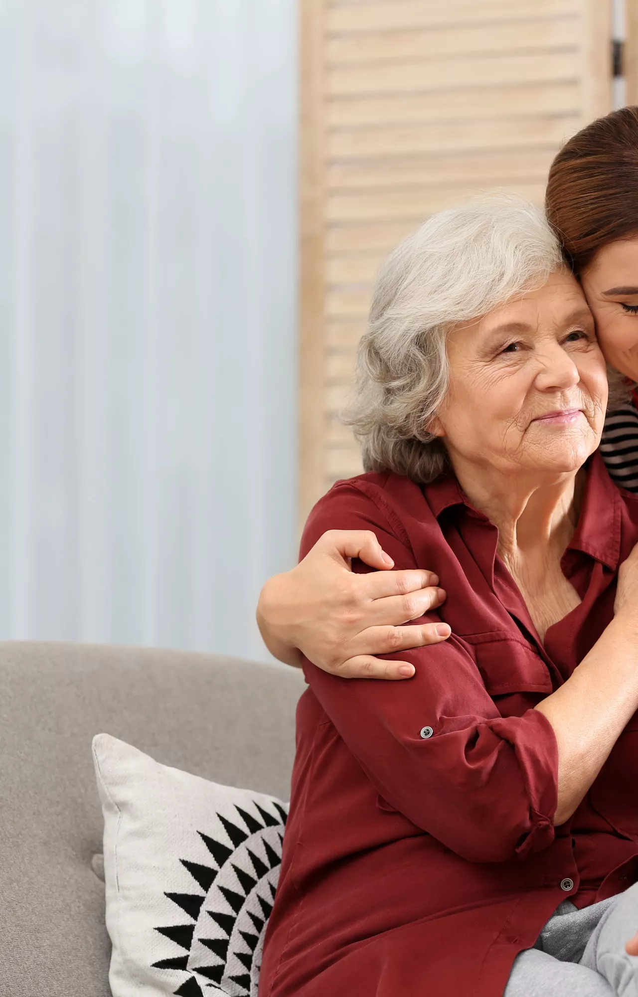 Jüngere Frau hält ältere Frau im Arm