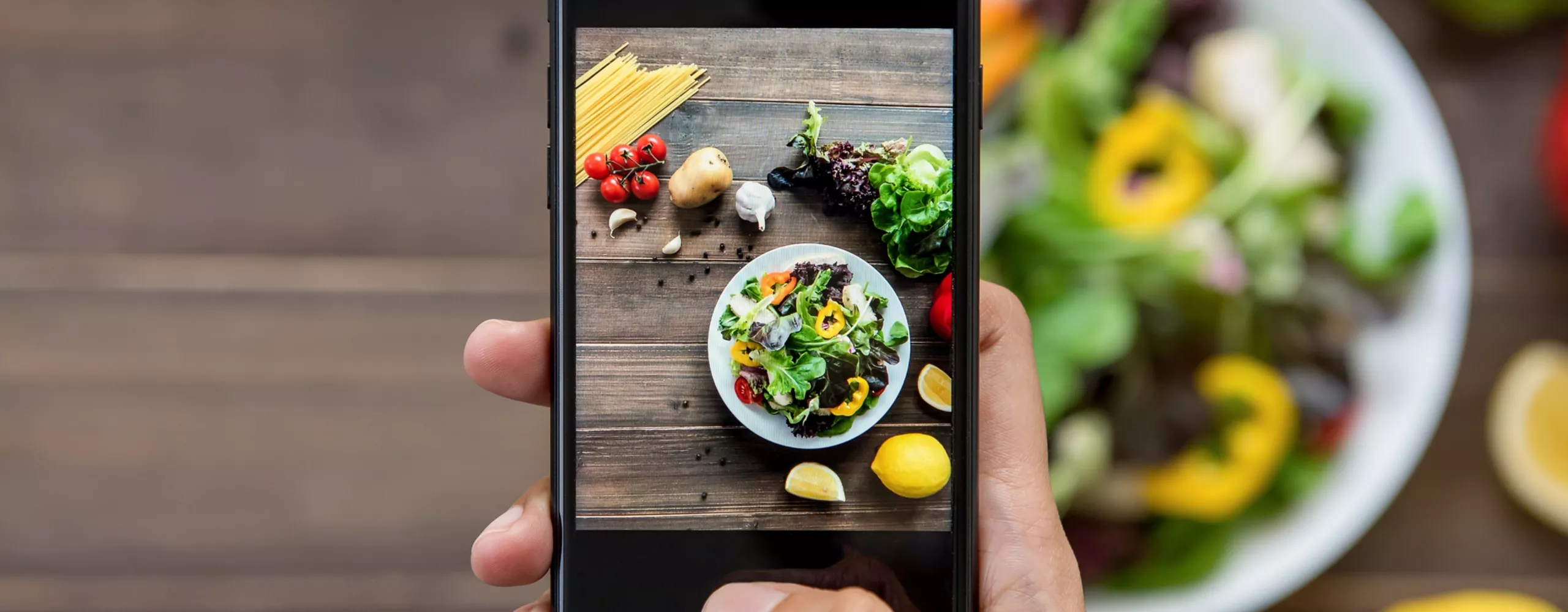 Person macht Bild von Salat