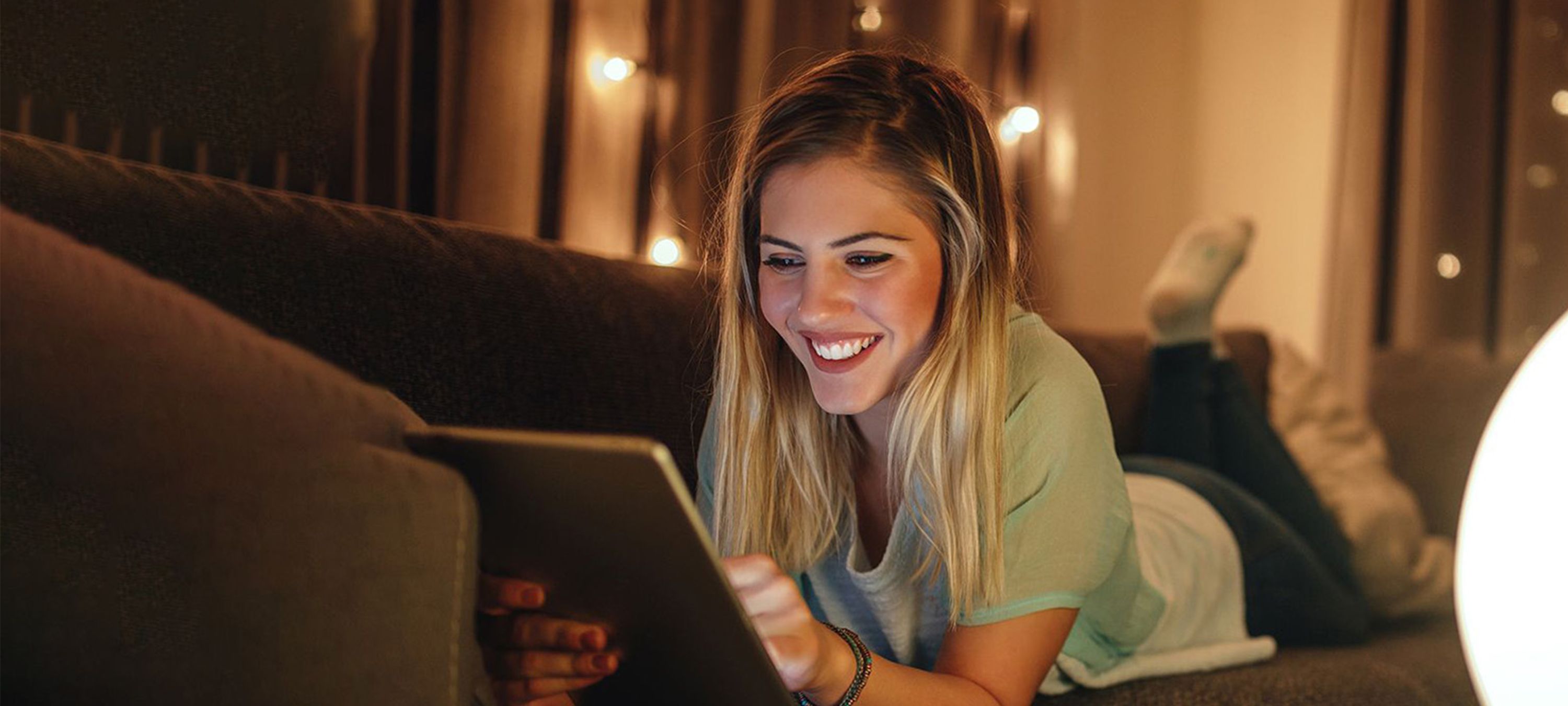 Frau mit Tablet auf dem Sofa