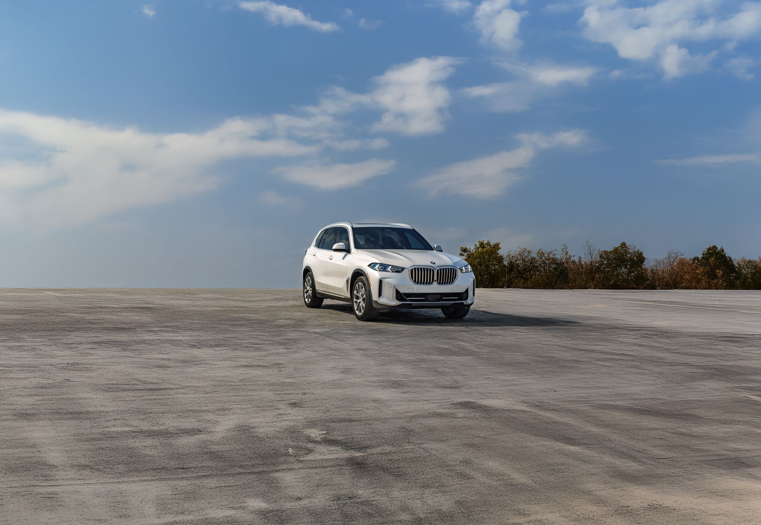 Side angle shot of a 2026 BMW X5 xDrive40i parked on pavement
