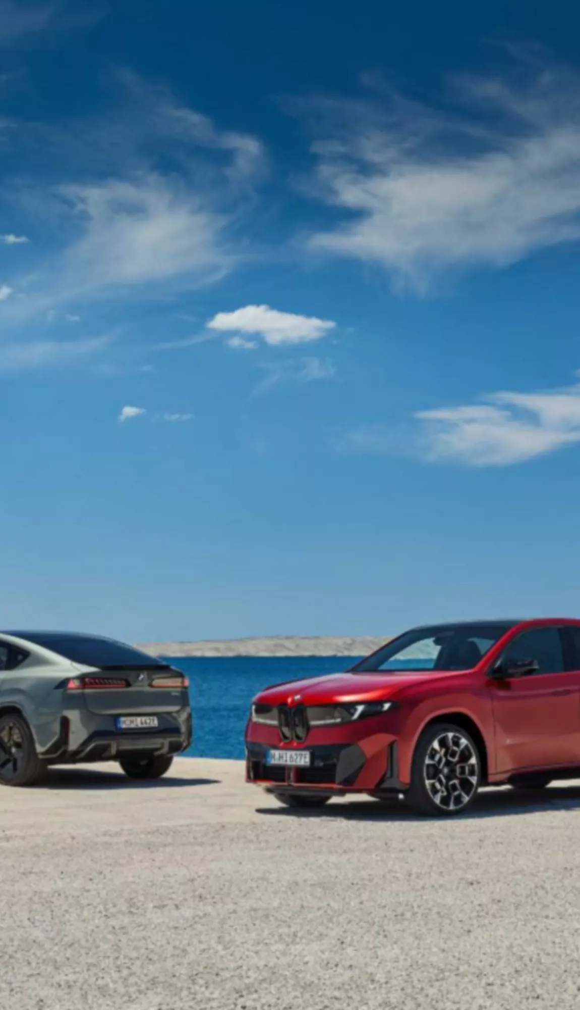 Side-by-side view of the all-electric BMW iX4 40 xDrive in Oxide Grey alongside the high-performance iX4 M60 xDrive in Frozen Pure Red. BMW Australia has confirmed local arrival for, the iX4, the third Neue Klasse platform EV.
