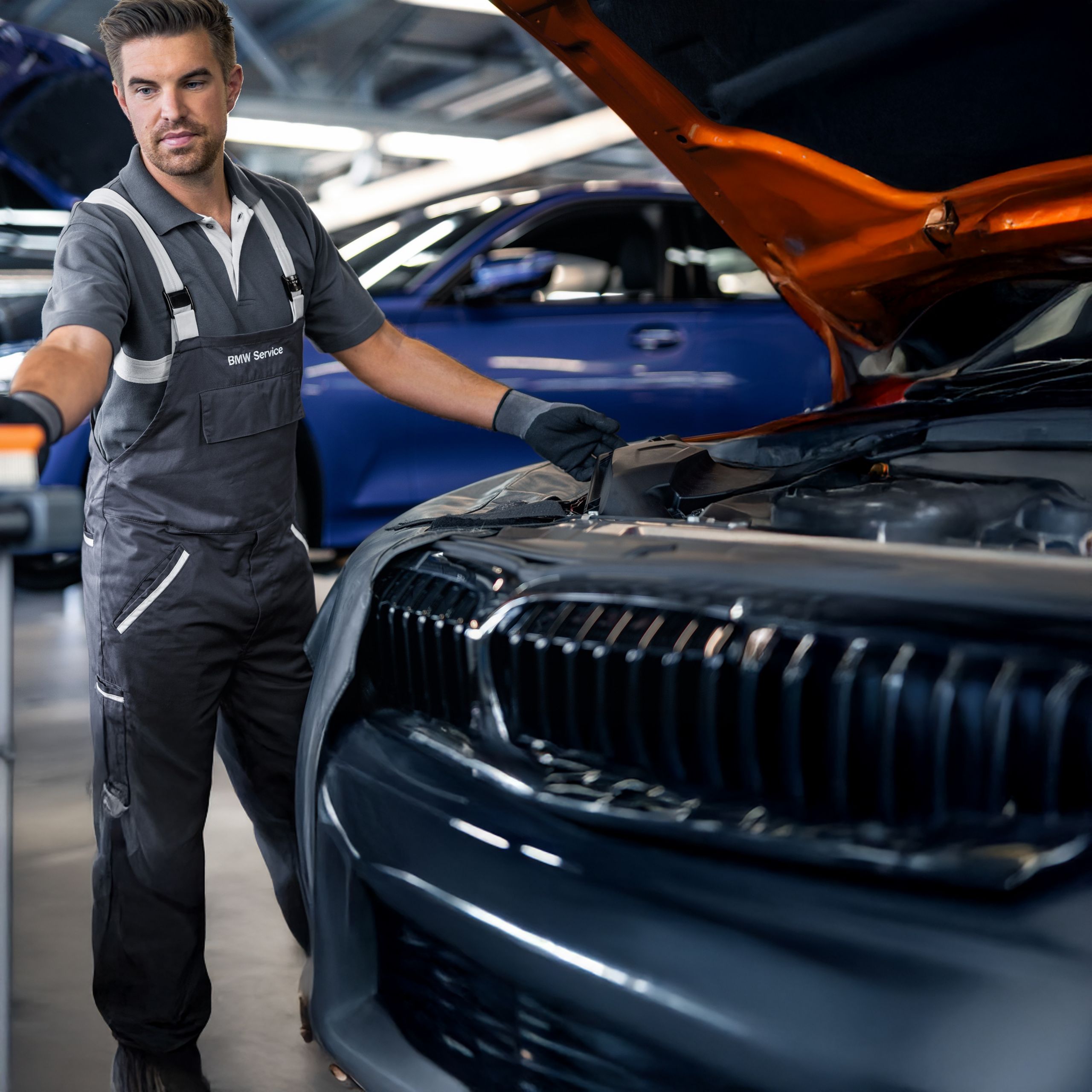 Mechanic working on car in garage