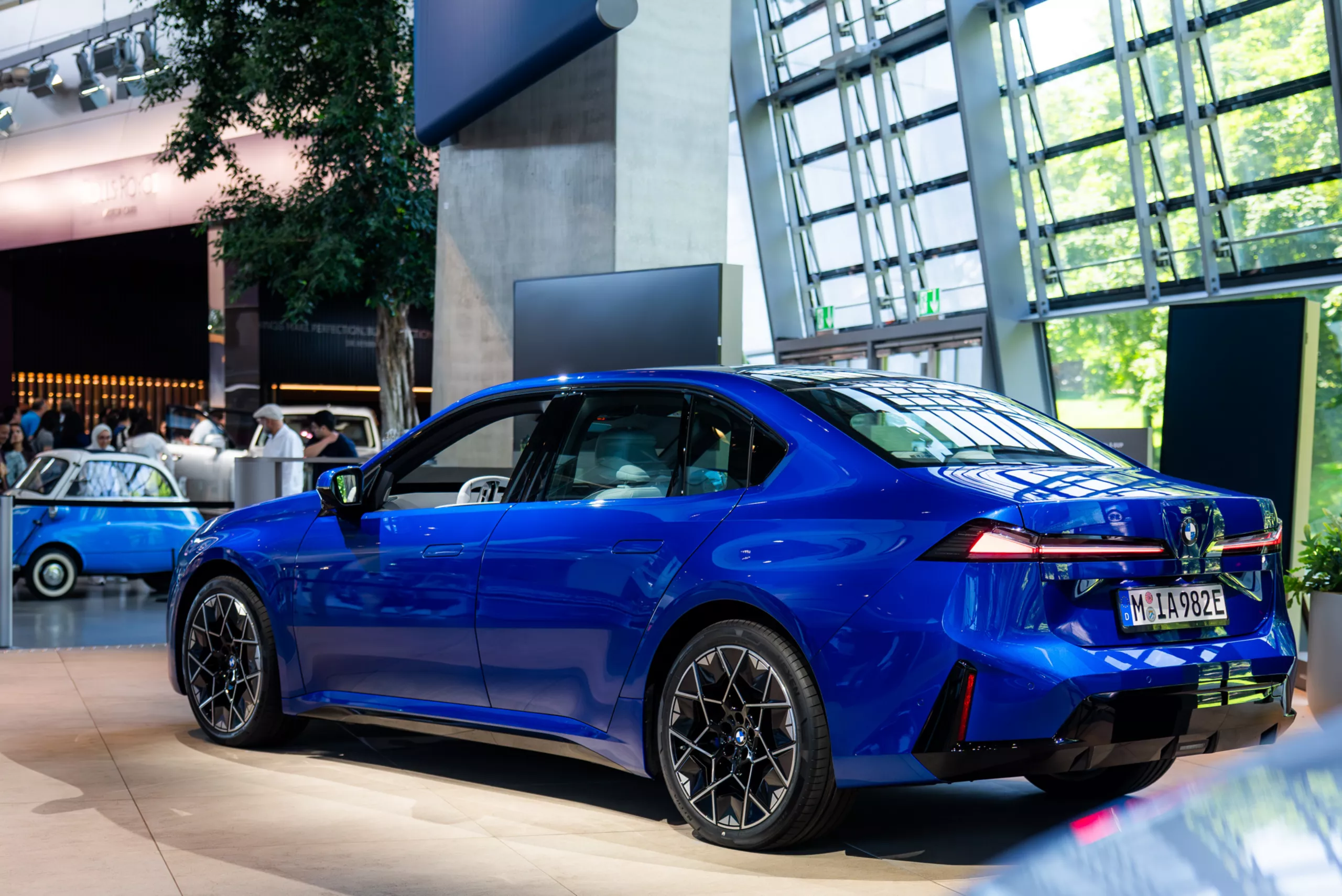 Diagonally side view of a blue BMW i3 at BMW Welt.