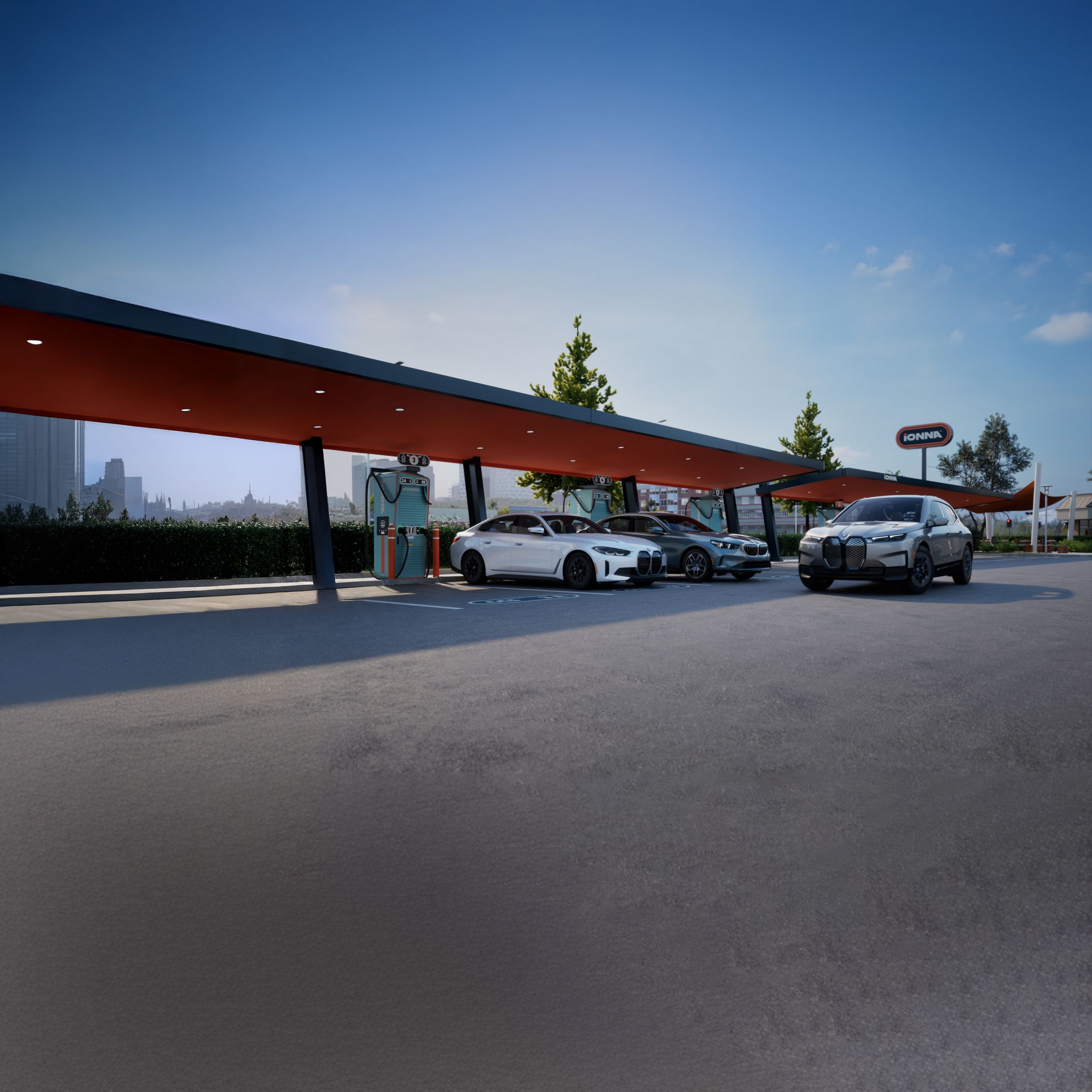 A BMW Certified i4, i5, and iX parked under the canopy of an IONNA charging station