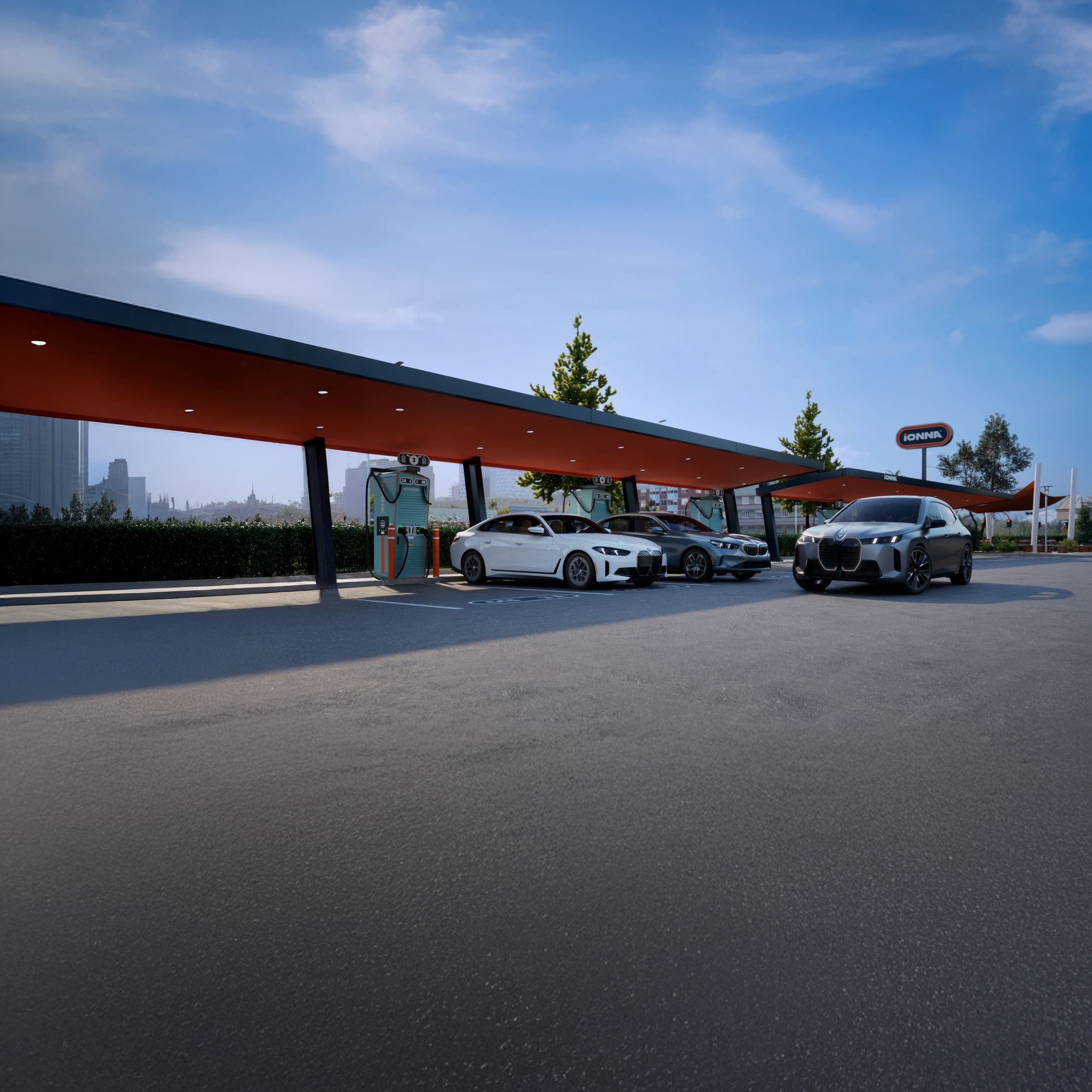 A BMW i4, i5, and iX parked at an IONNA charging station.