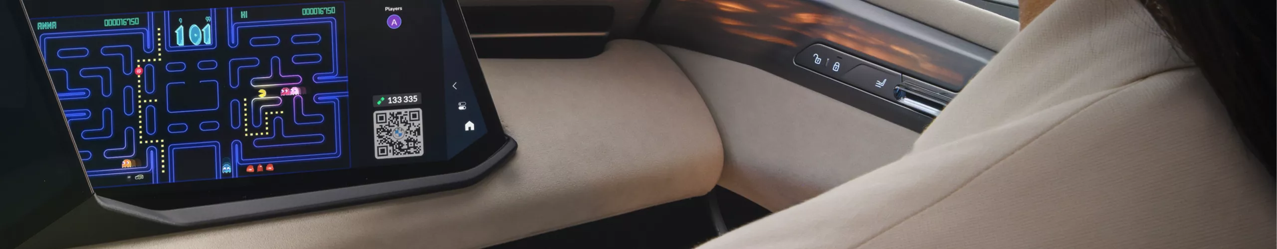 A woman plays a video game on the available Passenger Screen of the BMW X5.