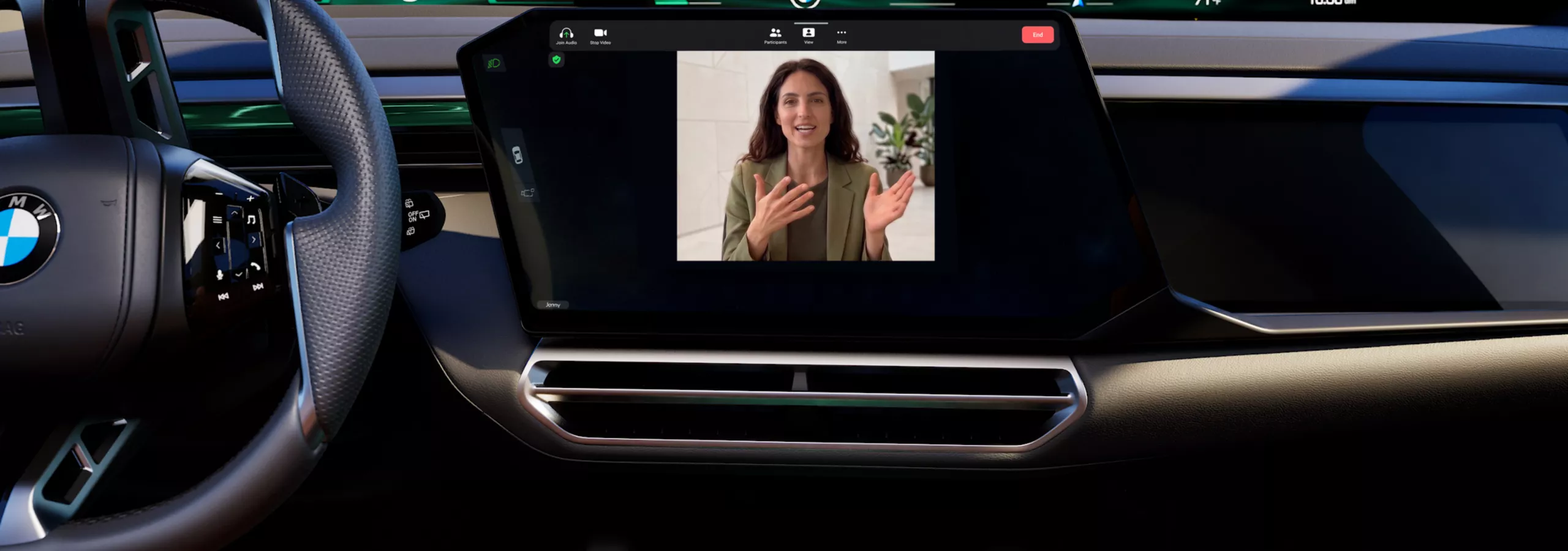 The cockpit of the BMW X5 with a woman on the display screen during a video call.