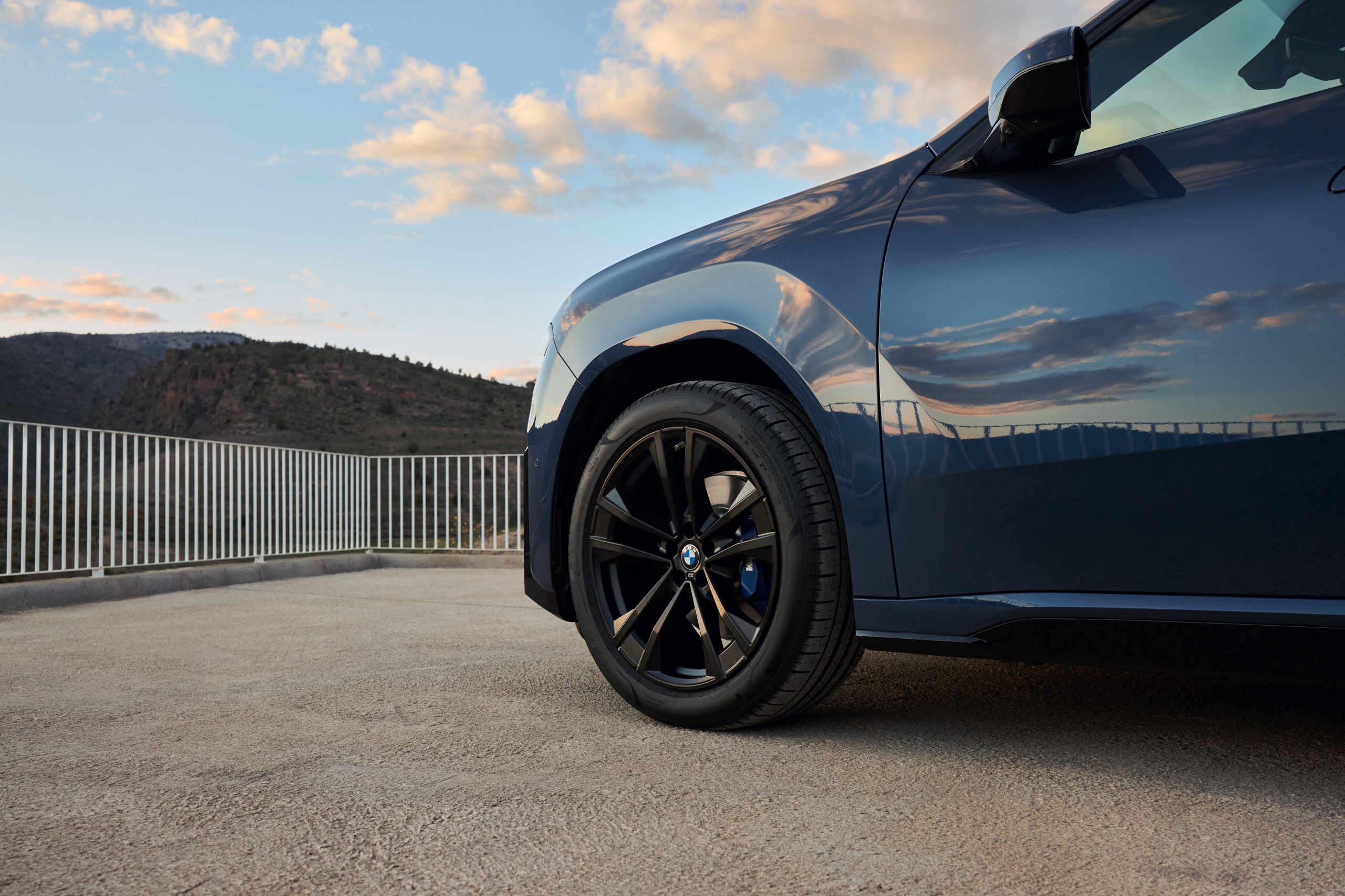 BMW iX3 with a black rim stands on a platform