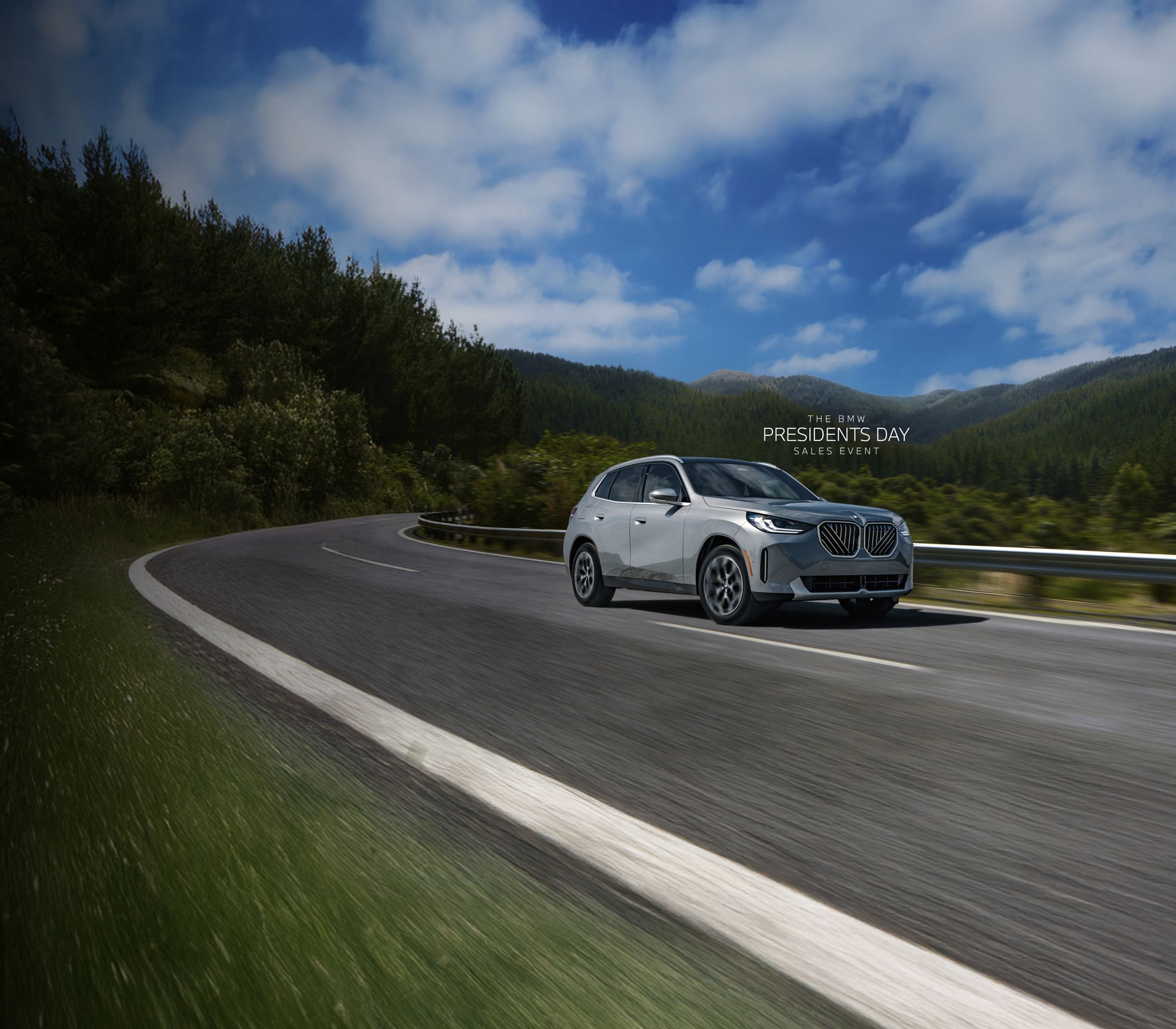 A BMW X3 drives on a winding mountain road