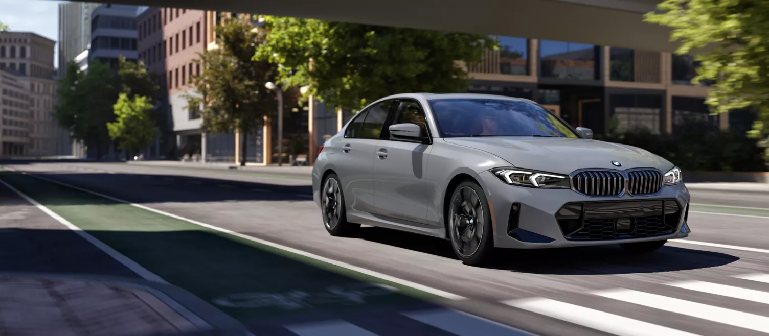 BMW 3 Series Sedan driving through a city