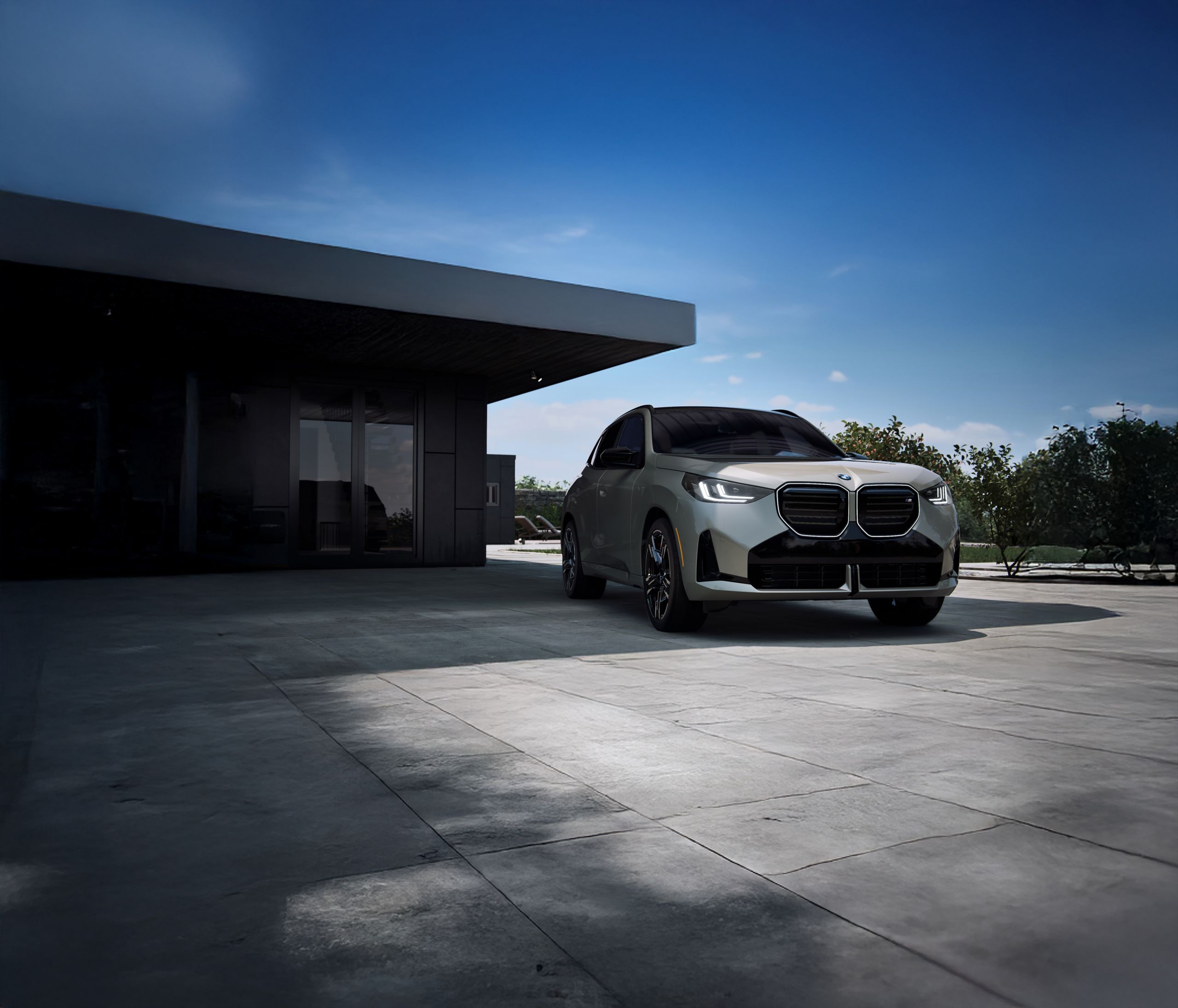 A BMW X3 SUV parked in the shade of an overhang on a sunny day