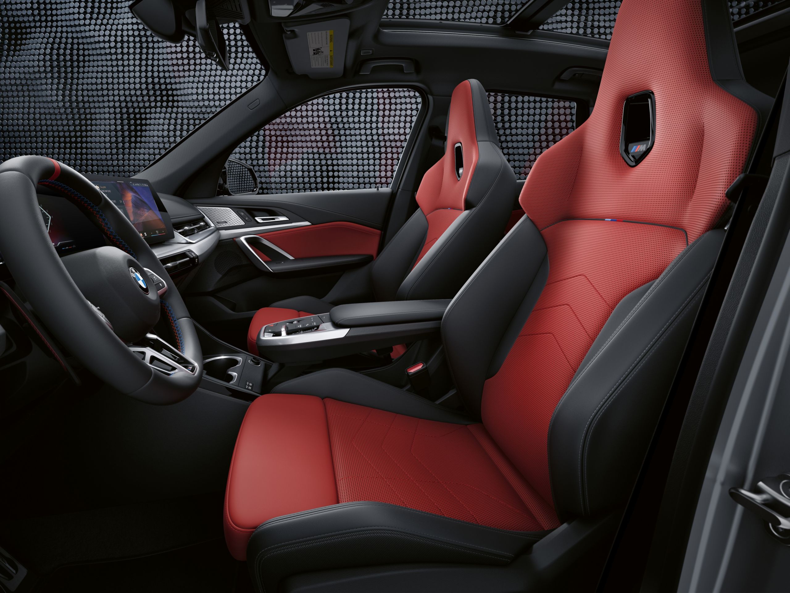 Interior shot of the 2026 BMW X1 M35i's available M Sport seats in red and black.
