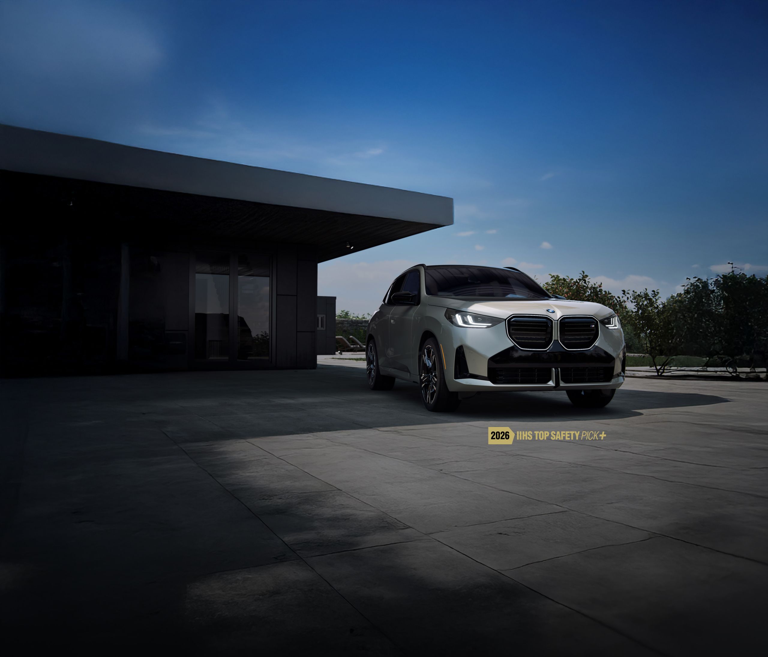 The BMW X3 parked in front of a modern home.