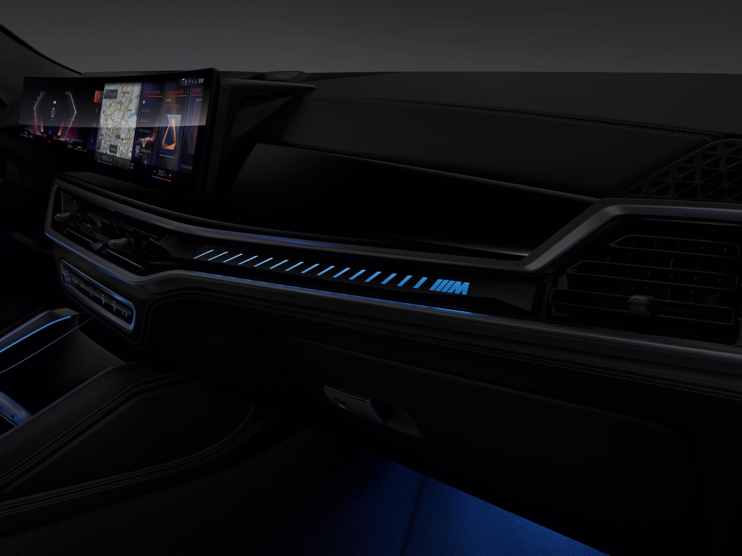 Detail of the interior with M lighting strip and illuminated M logo on the front passenger's side