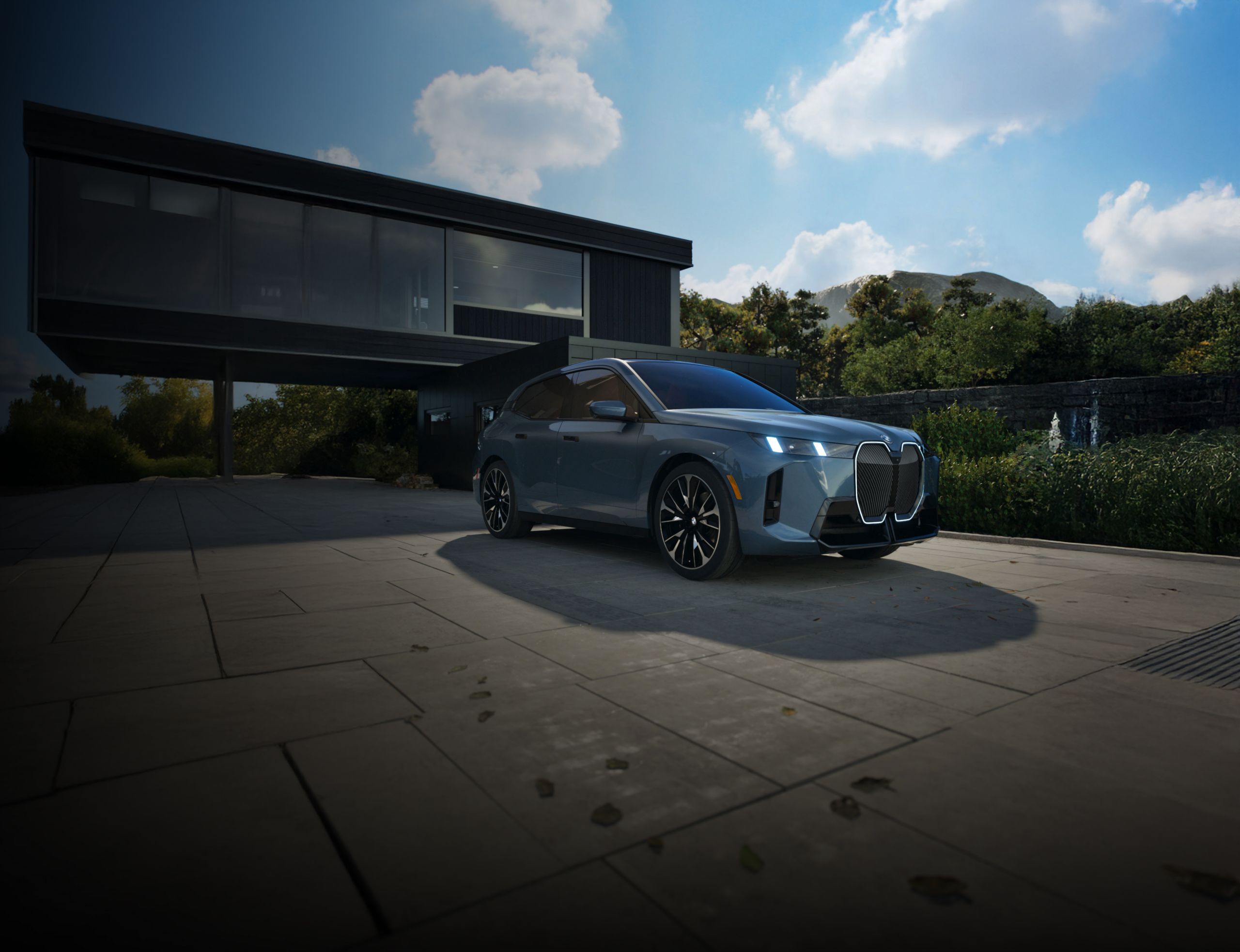 The 2026 BMW iX SUV parked in front of a modern home.