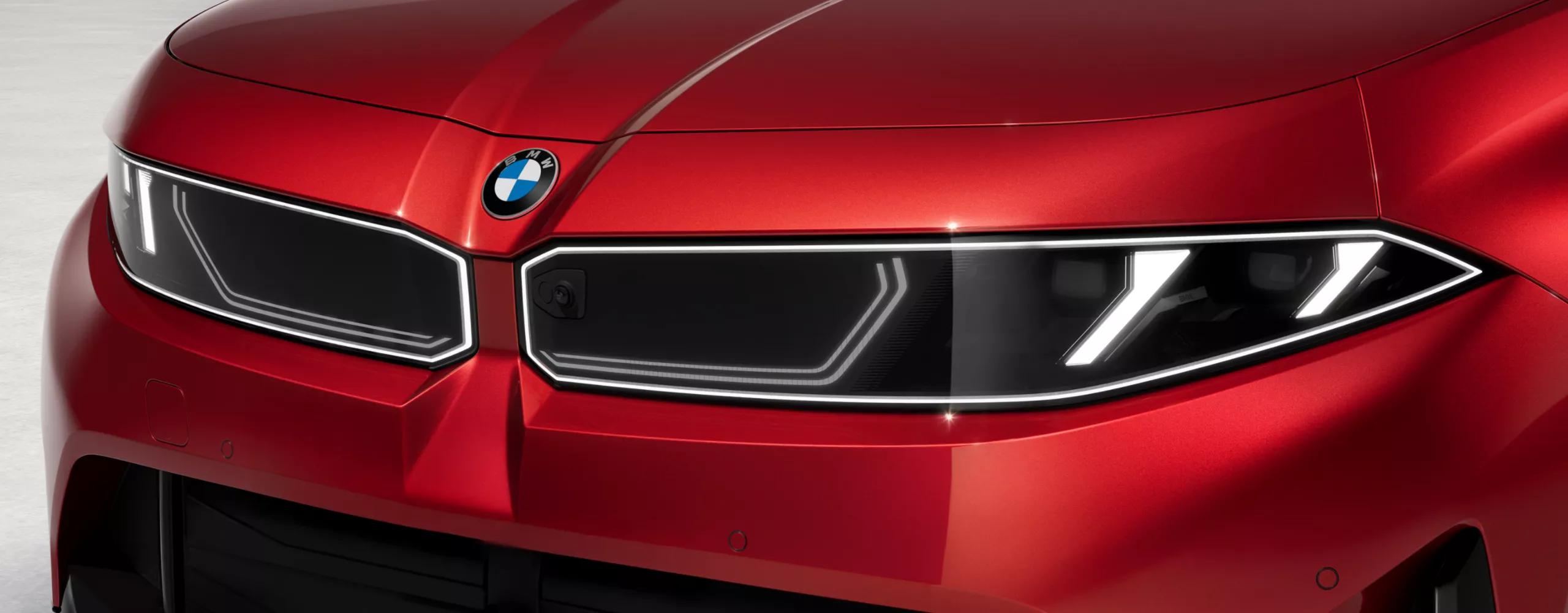 Close-up of BMW badge on the hood.