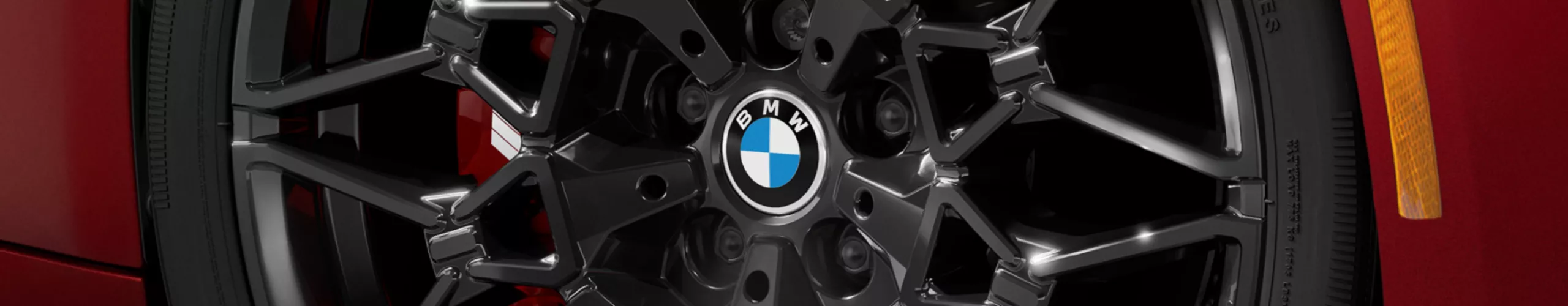 Detailed view of the turned front wheel with black 20-inch M rim 1141 M and M Sport brake.