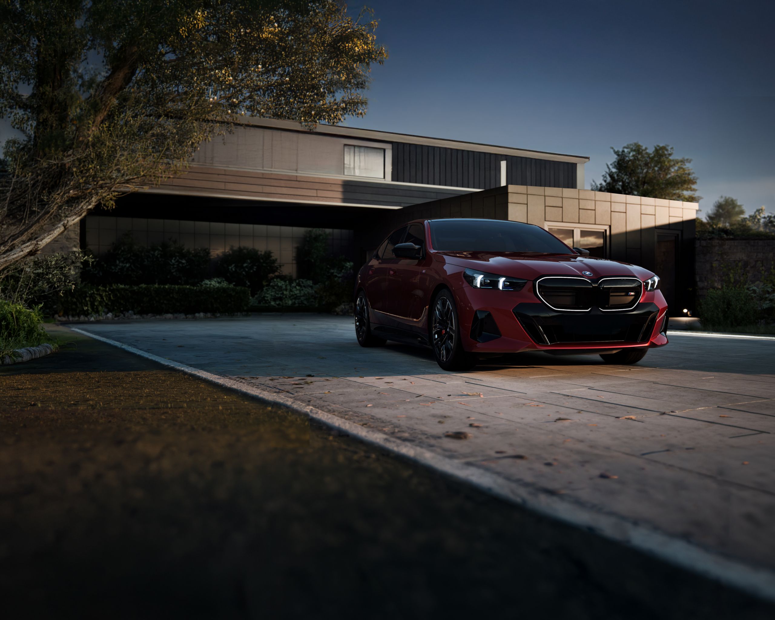 Heroic view of the BMW i5 Sedan with glowing kidney grille parked in front of a modern building