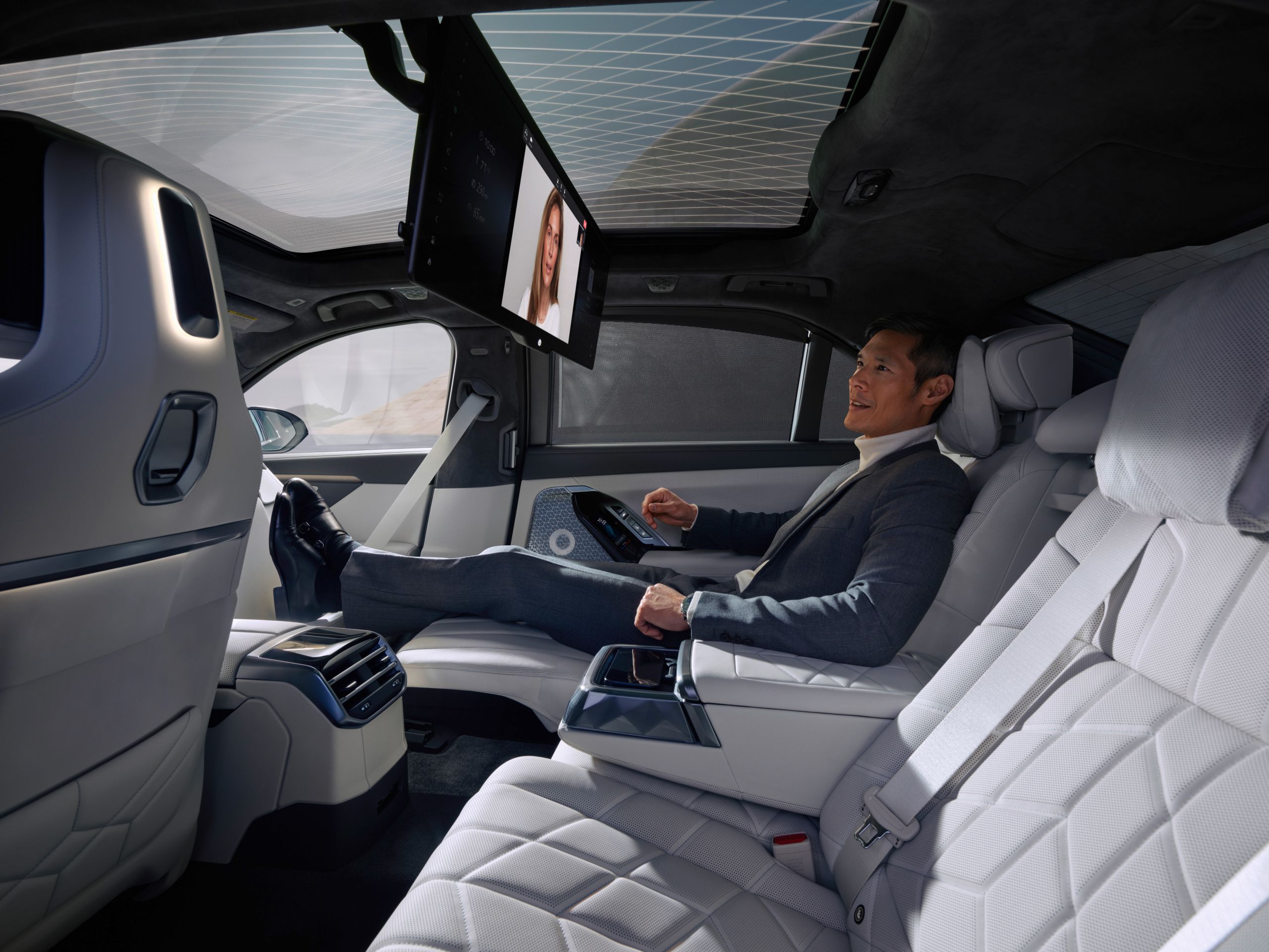Close-up of a person holding a video conference in the back seat.