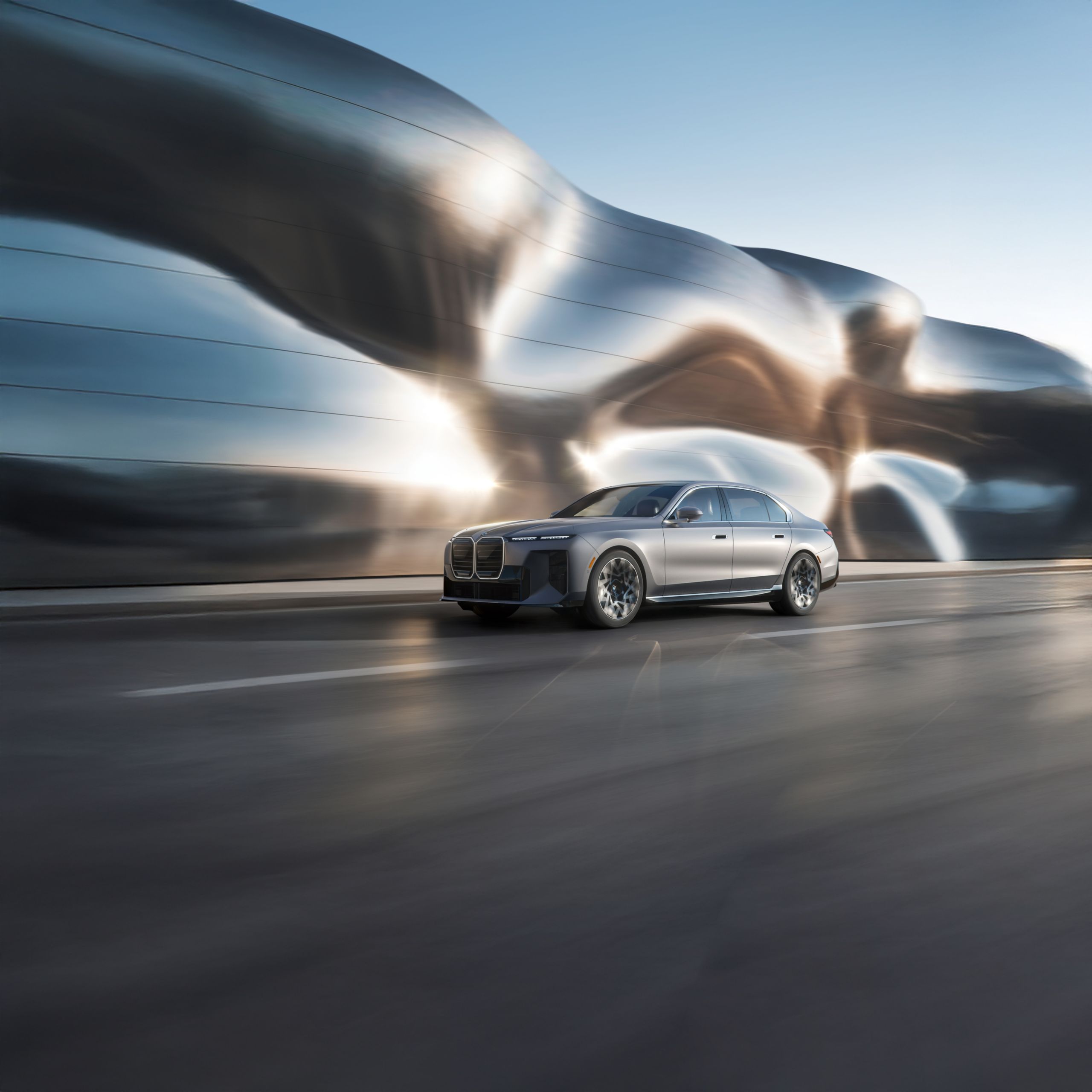 The BMW i7 on a showroom floor with abstract light behind it