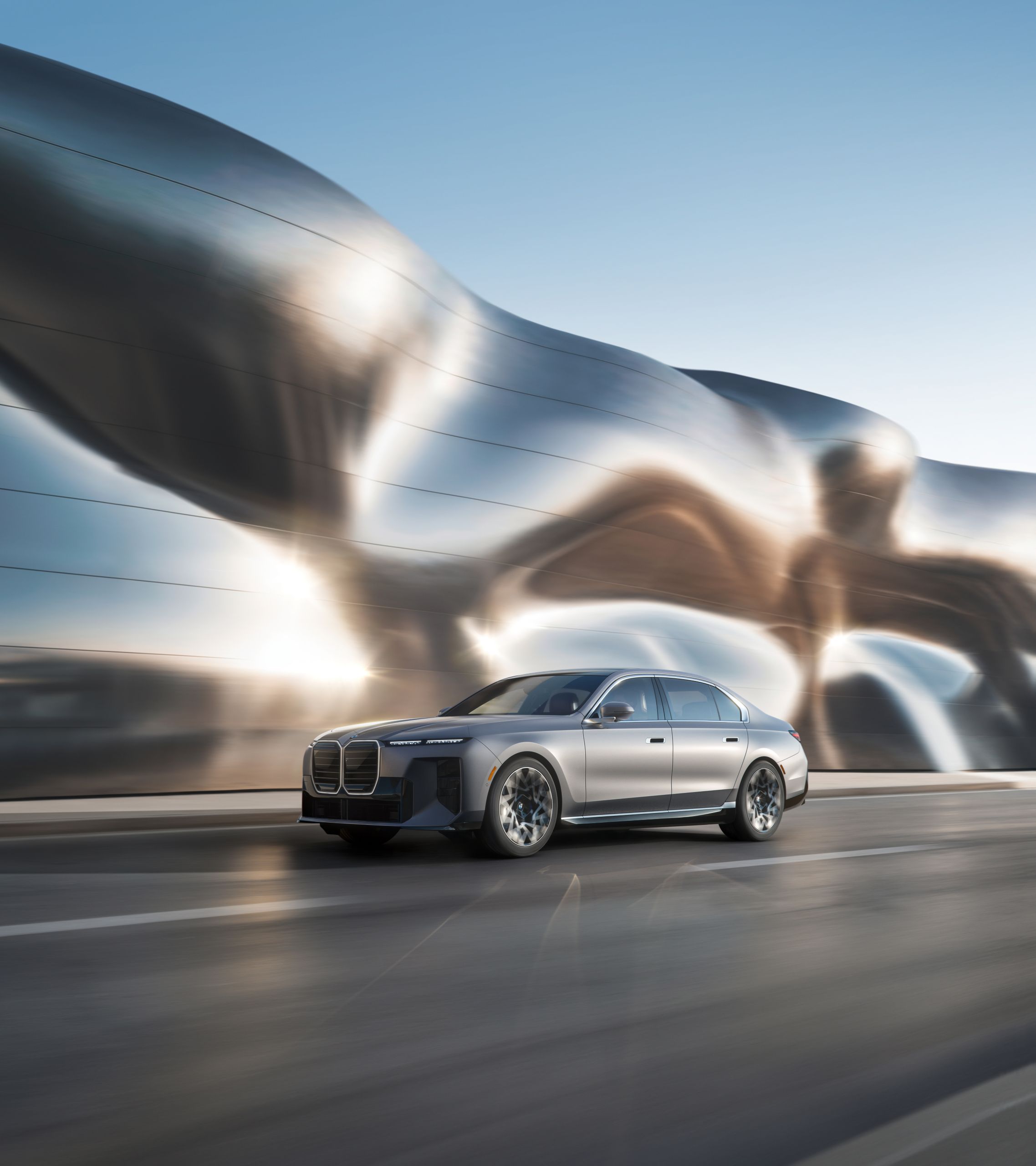An all-electric BMW driving down a street with a swirling modern background