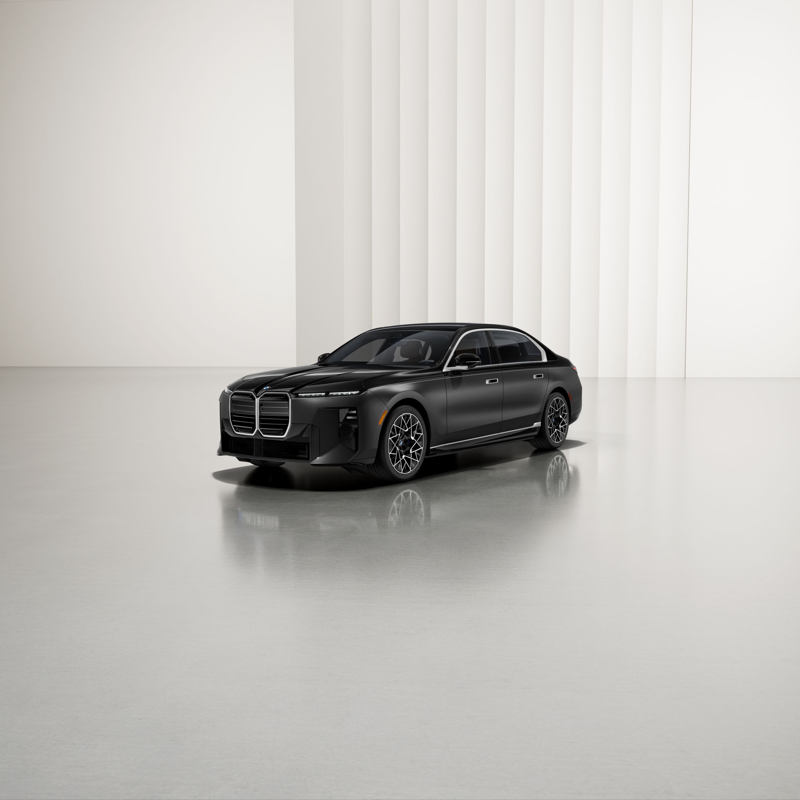 A BMW with two-tone paintwork at an angle on a reflective surface, with a modern background.
