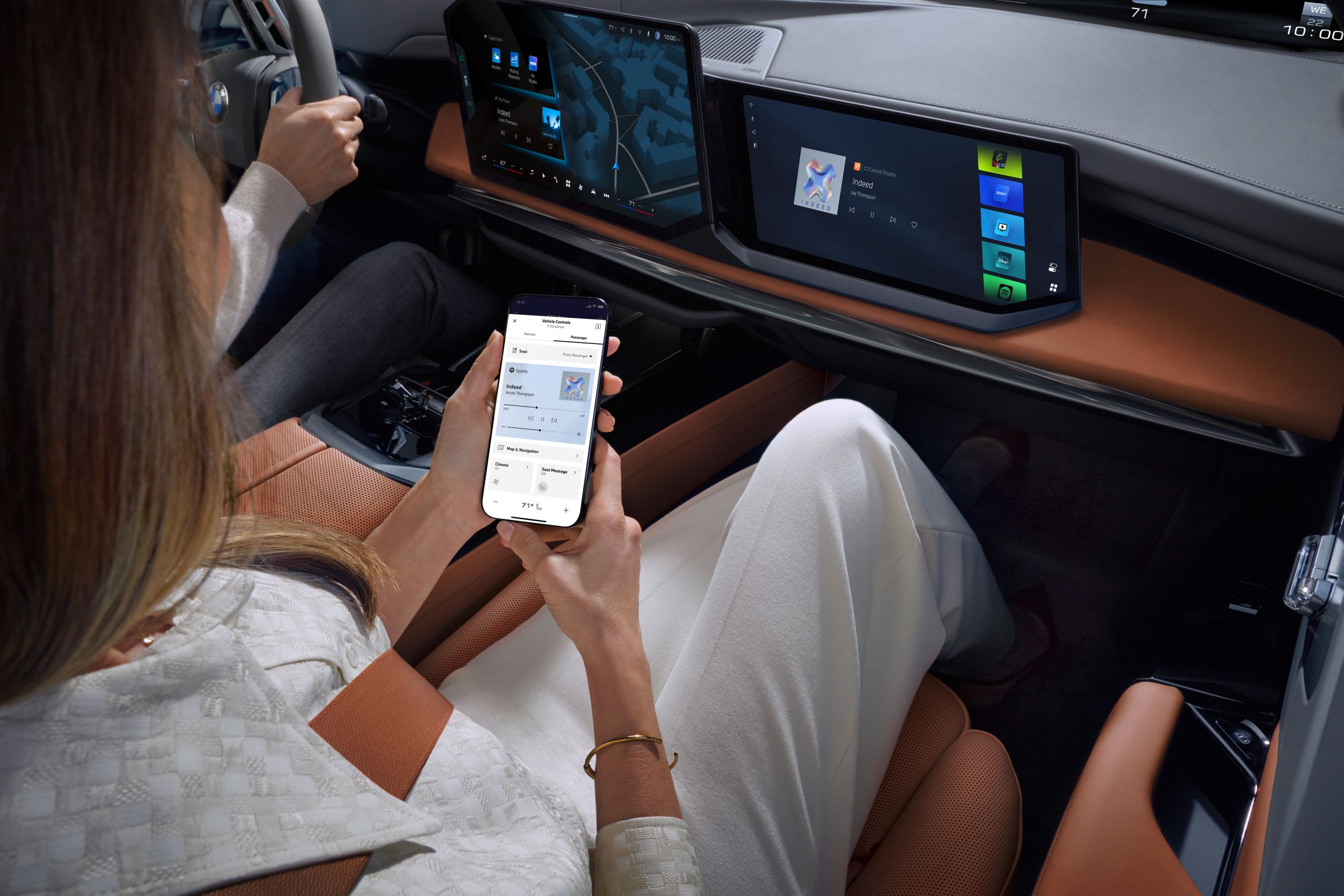 Person in the passenger seat operates a smartphone with the My BMW App.