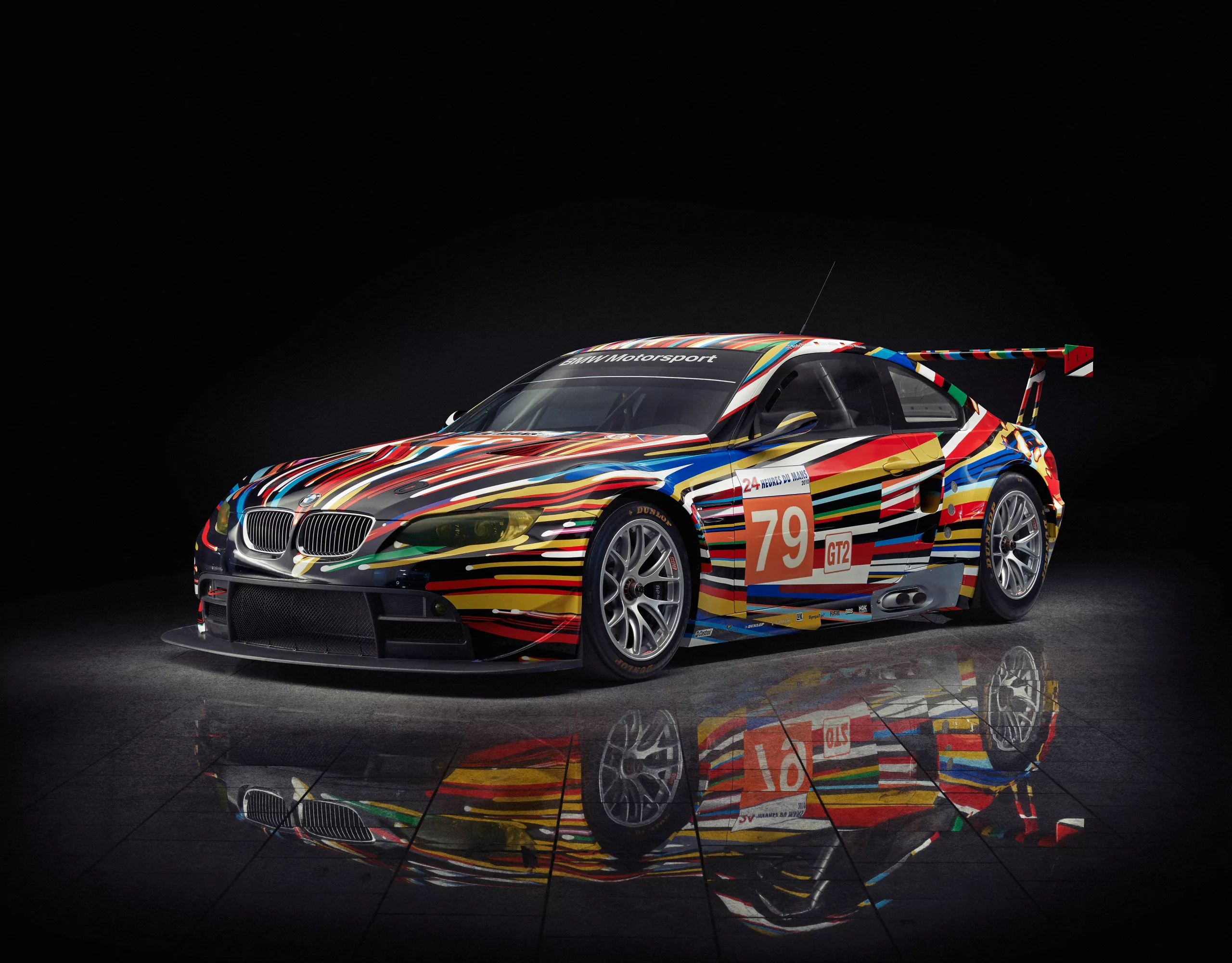  BMW M3 GT2 Art Car designed by artist Jeff Koons, featuring dynamic color explosions expressing speed and movement.