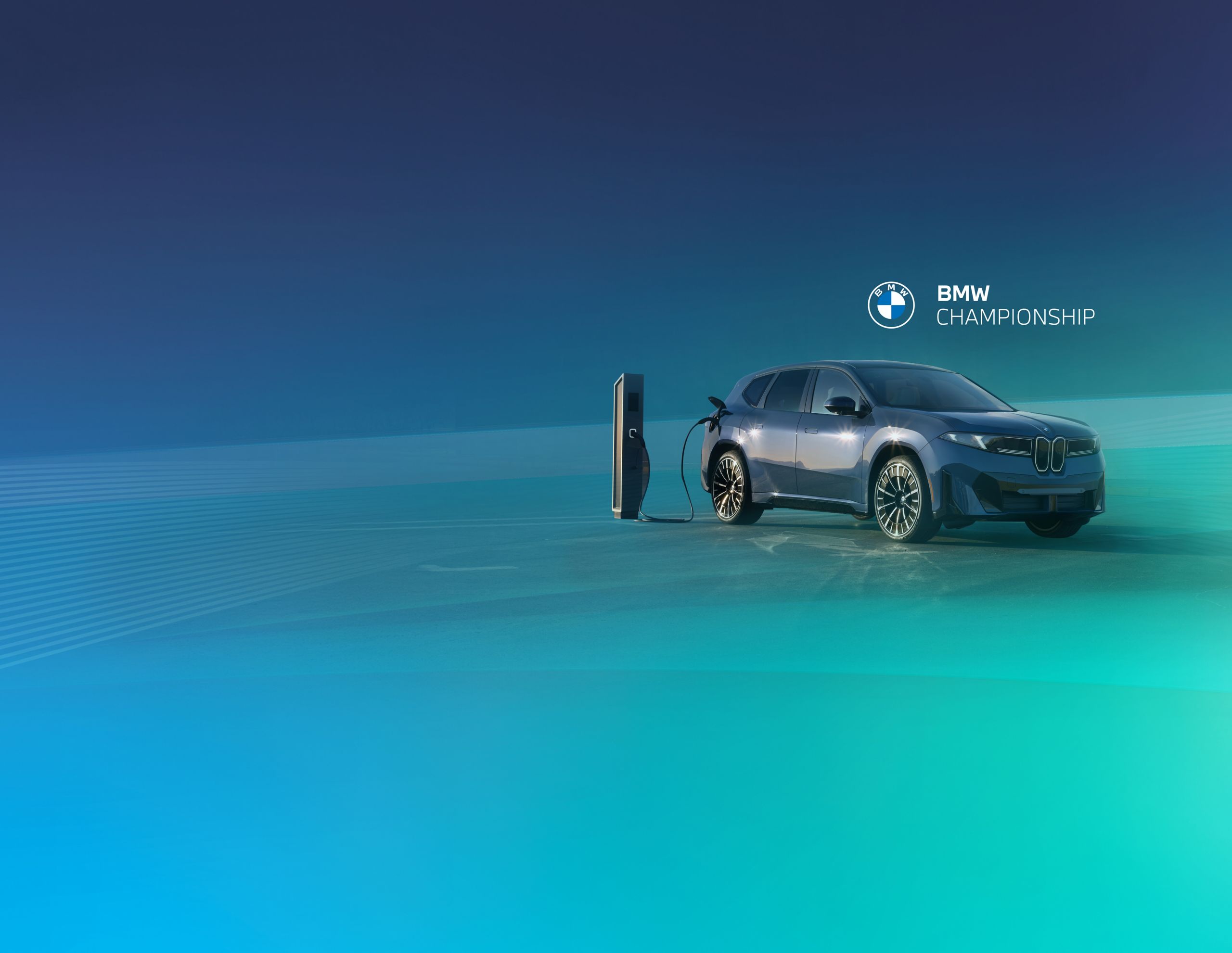 The BMW iX3 charges at a charging station within a bluish green studio space