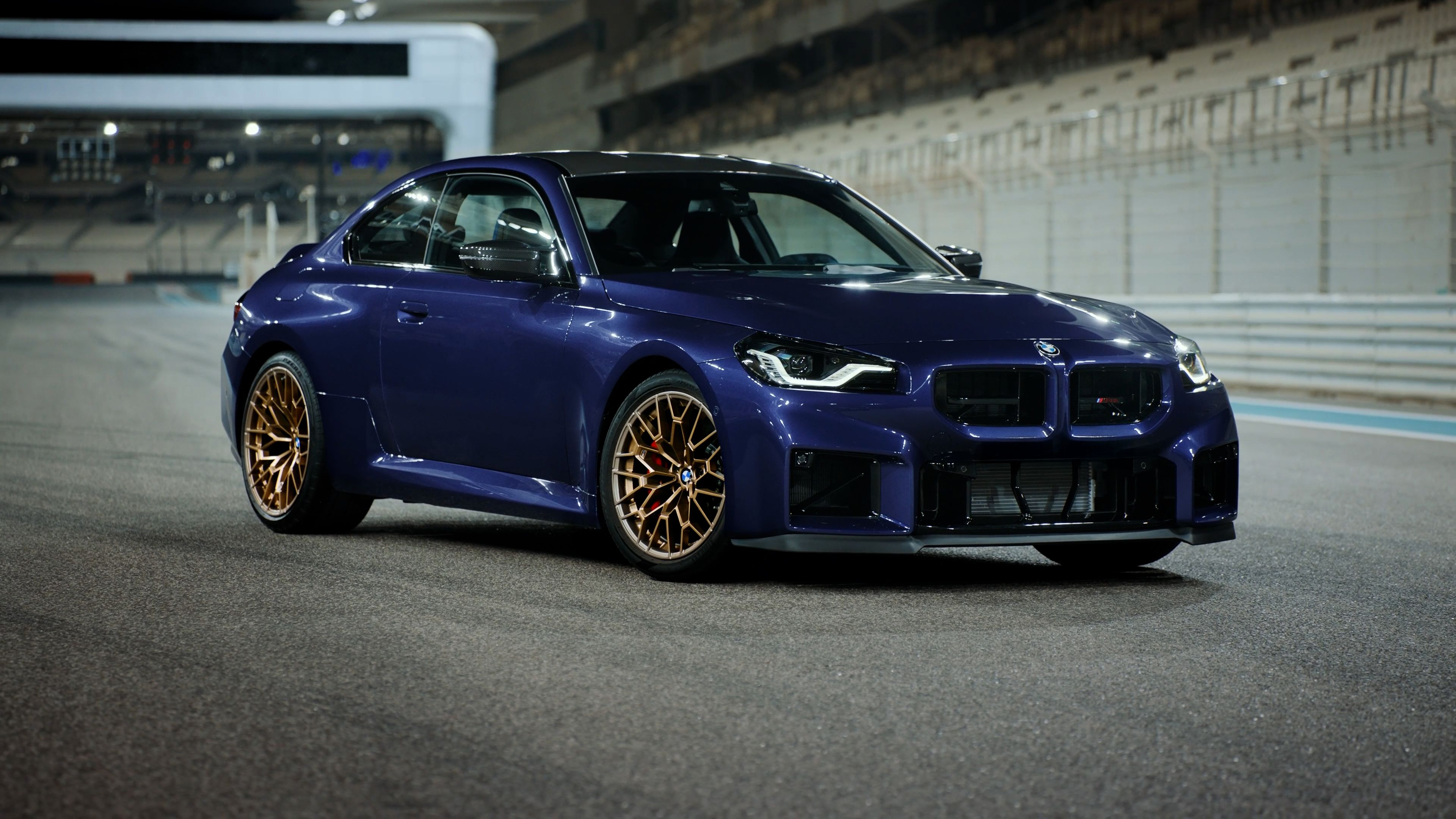 The BMW M2 CS driving fast over a scenic bridge