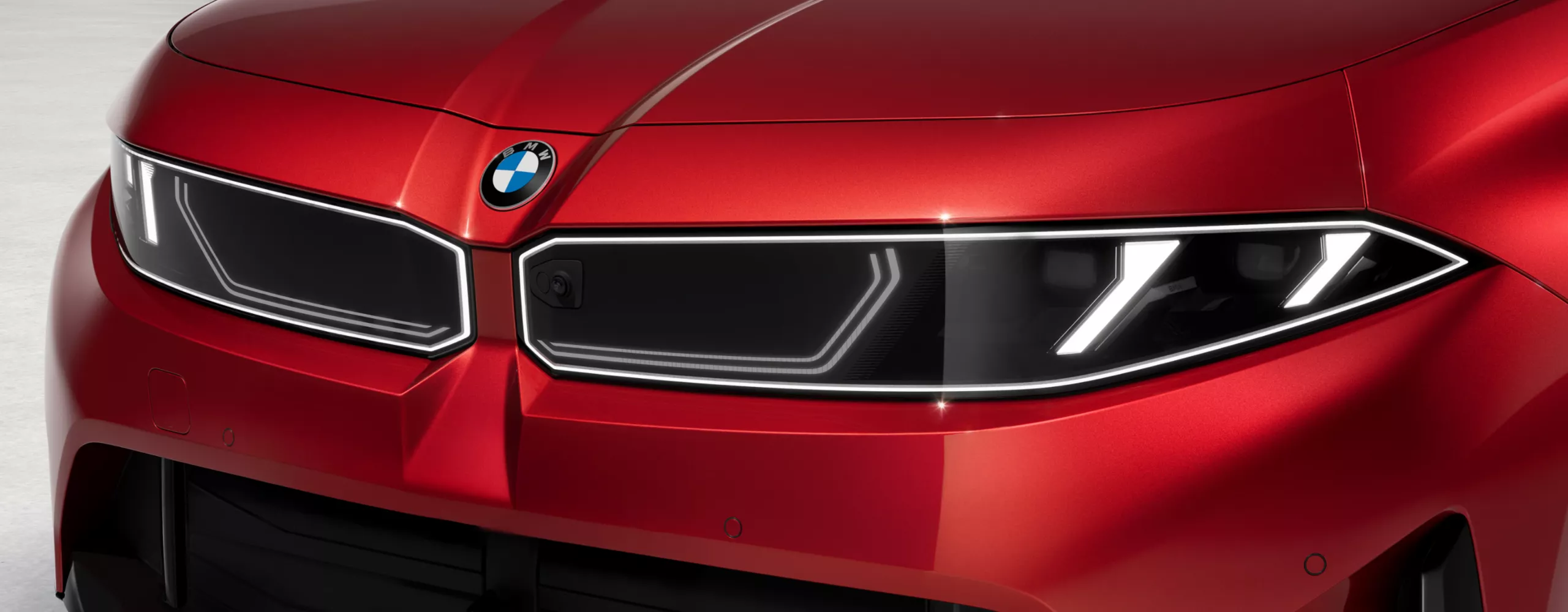 Close-up of BMW badge on the hood.