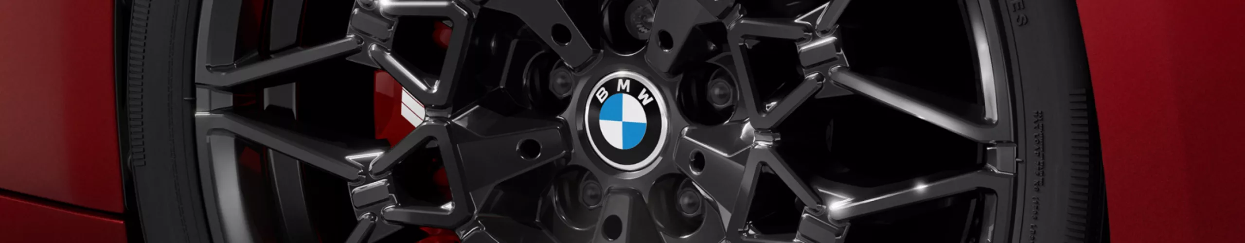 Detailed view of the turned front wheel with black 20-inch M rim 1141 M and M Sport brake.