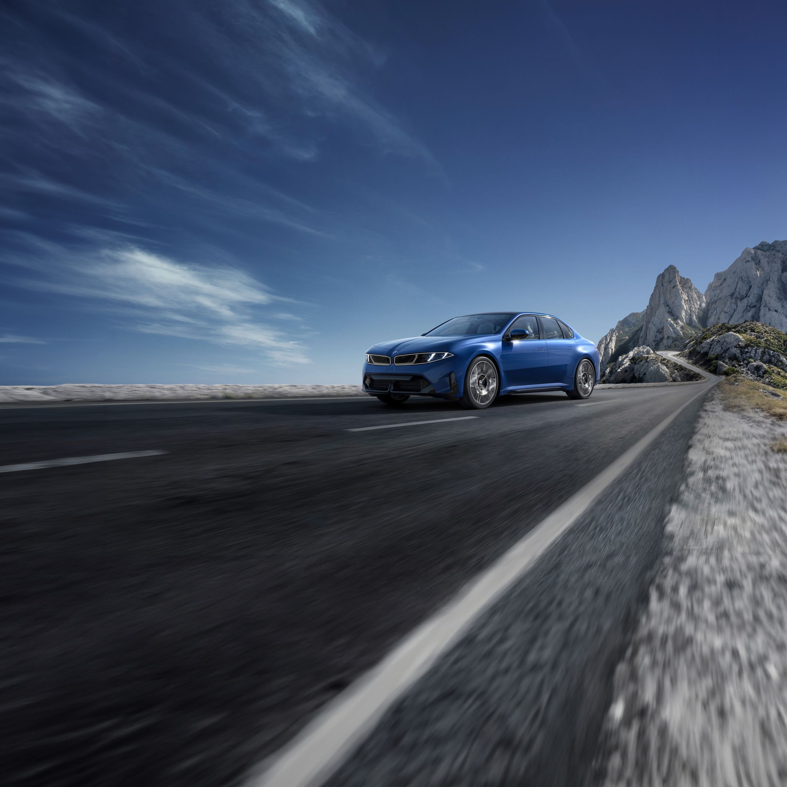 Side angle shot of the BMW i3 Sedan driving down a road