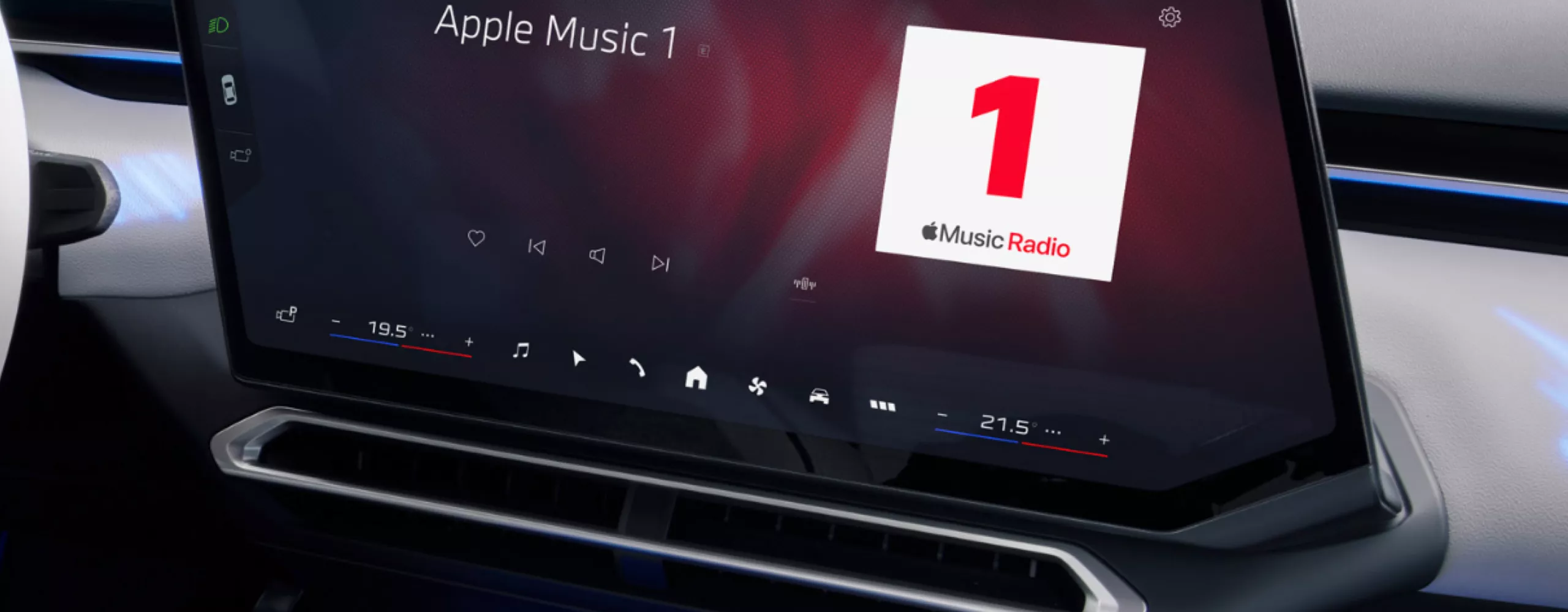 View from the driver's seat to the central display which shows a Apple Music radio station.