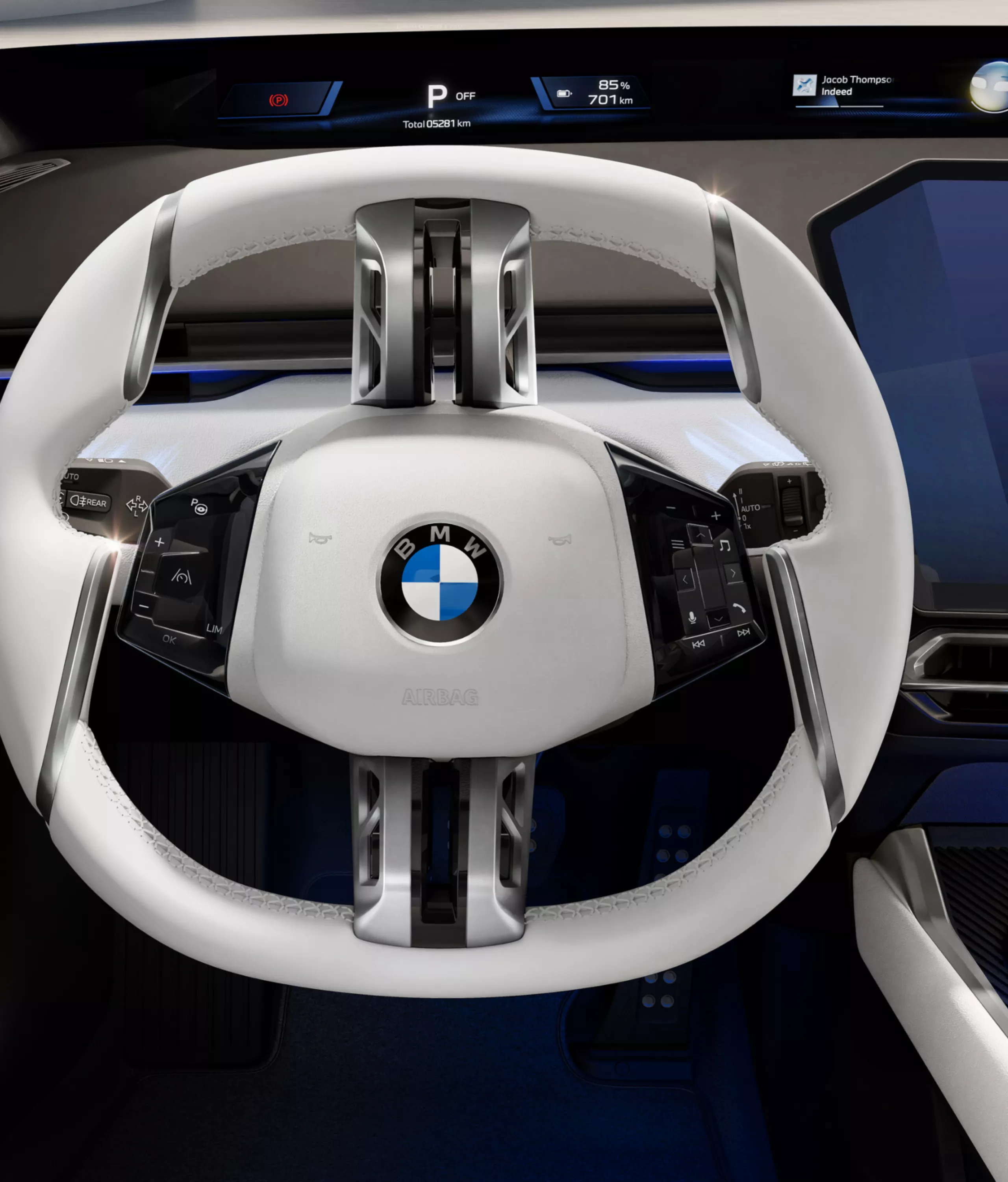 View from the driver's seat of the white steering wheel with almost invisible operating elements.