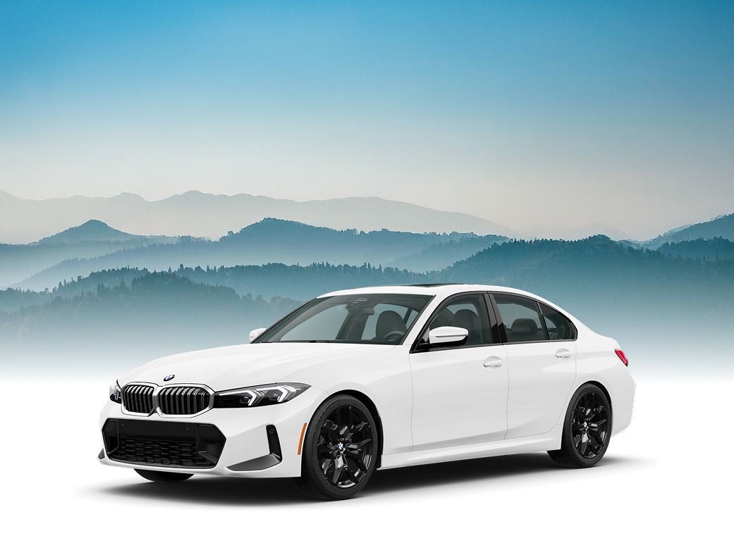 A BMW 3 Series with a silhouetted forest landscape in the background