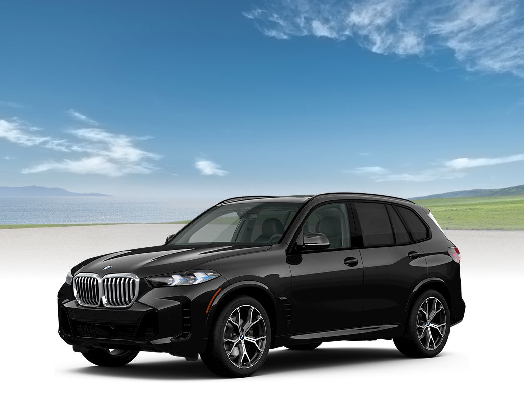 A BMW X5 with a grassy field and large body of water in the background