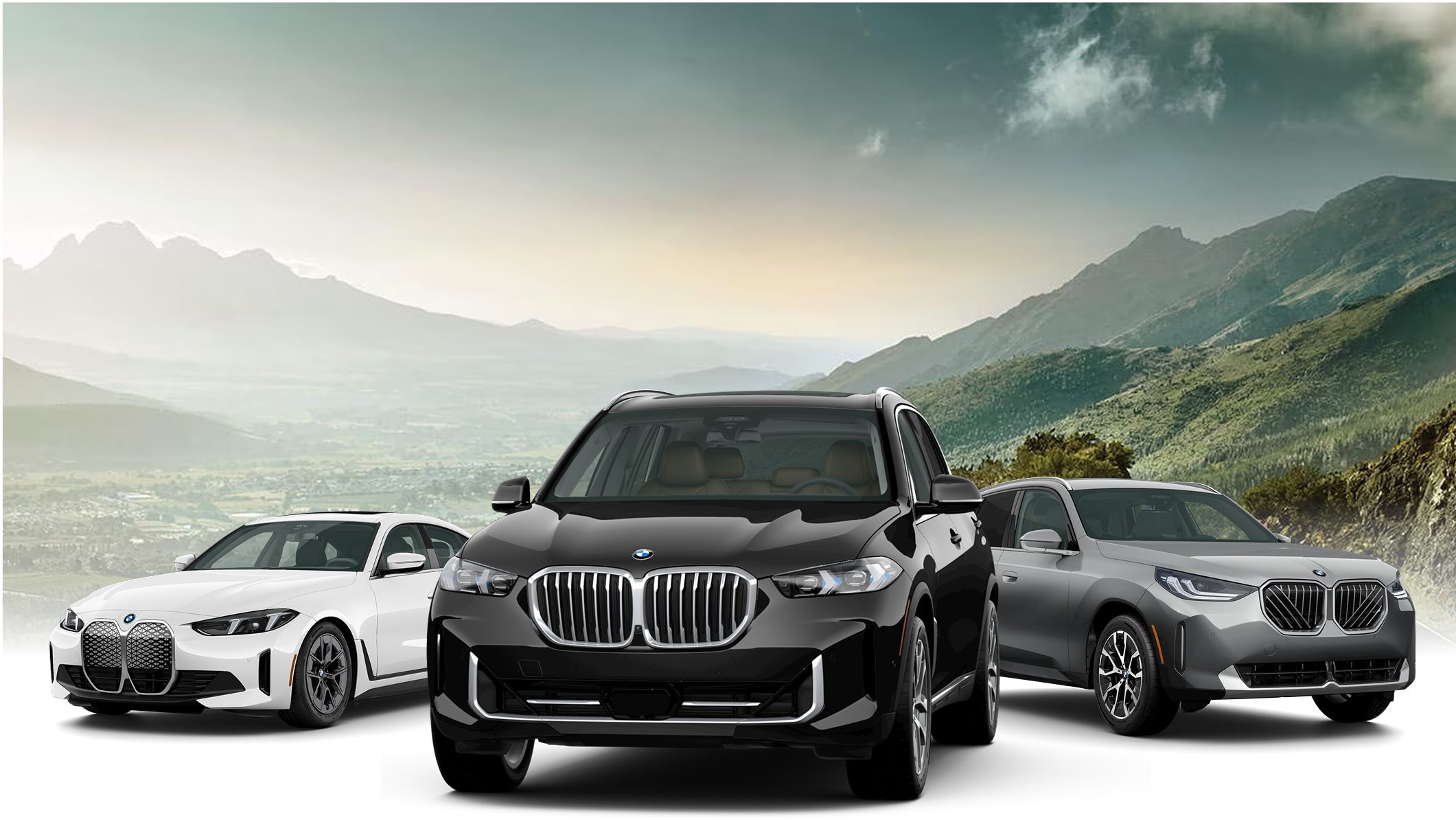 3 BMWs staged in front of a mountainous landscape.
