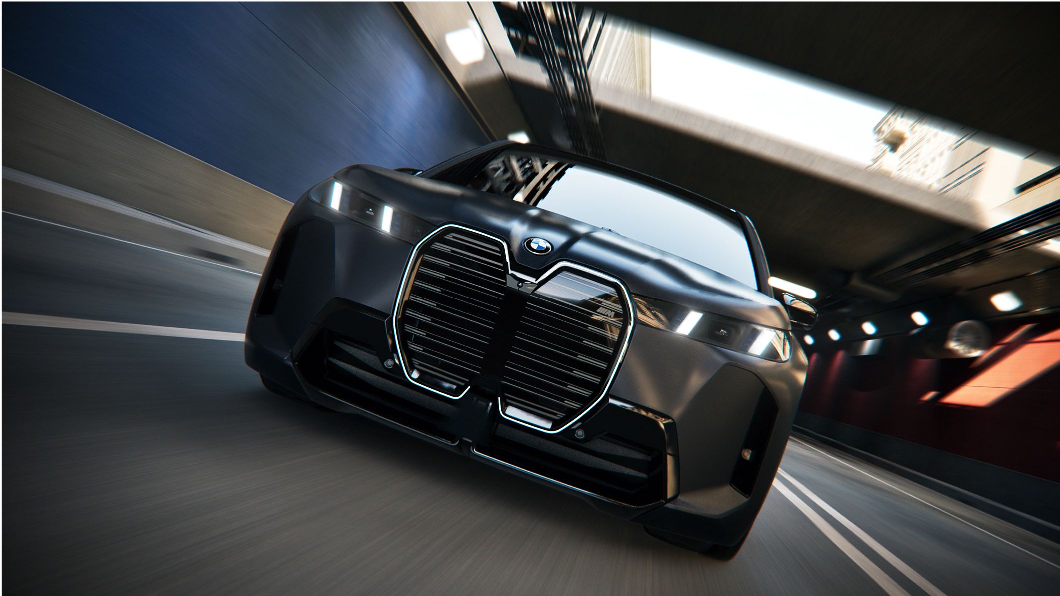 A dramatic shot of a BMW driving through an urban tunnel.