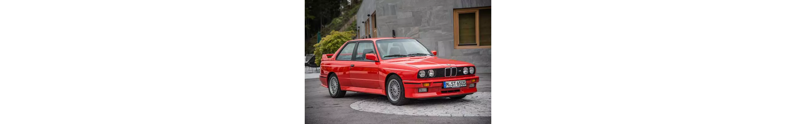 En röd BMW M3 parkerad på gatan.