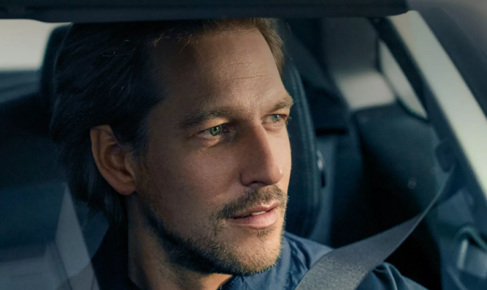 BMW Service Inclusive Man driving BMW looking through windshield