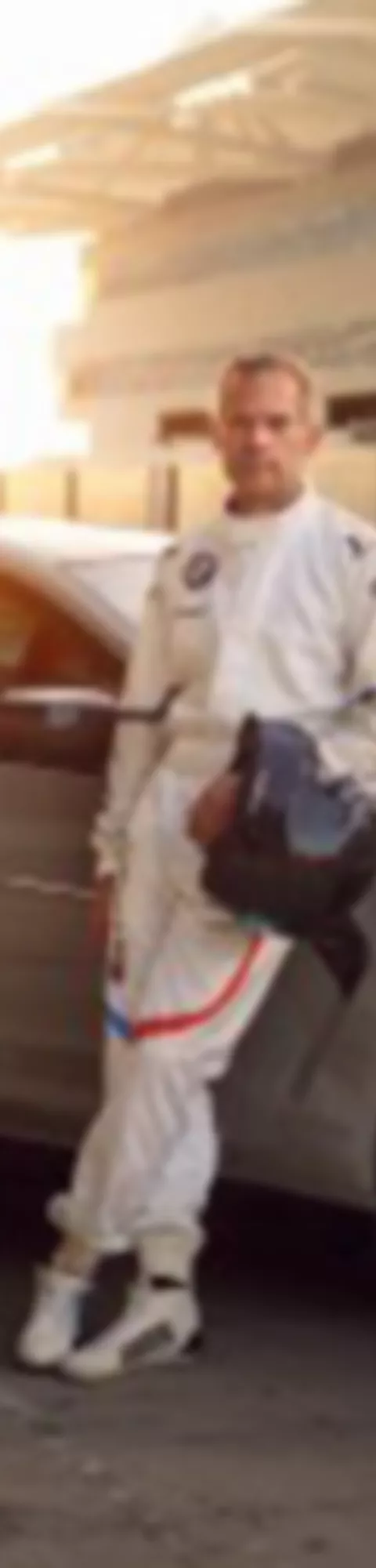 3 quarter shot of BMW with man leaning on car