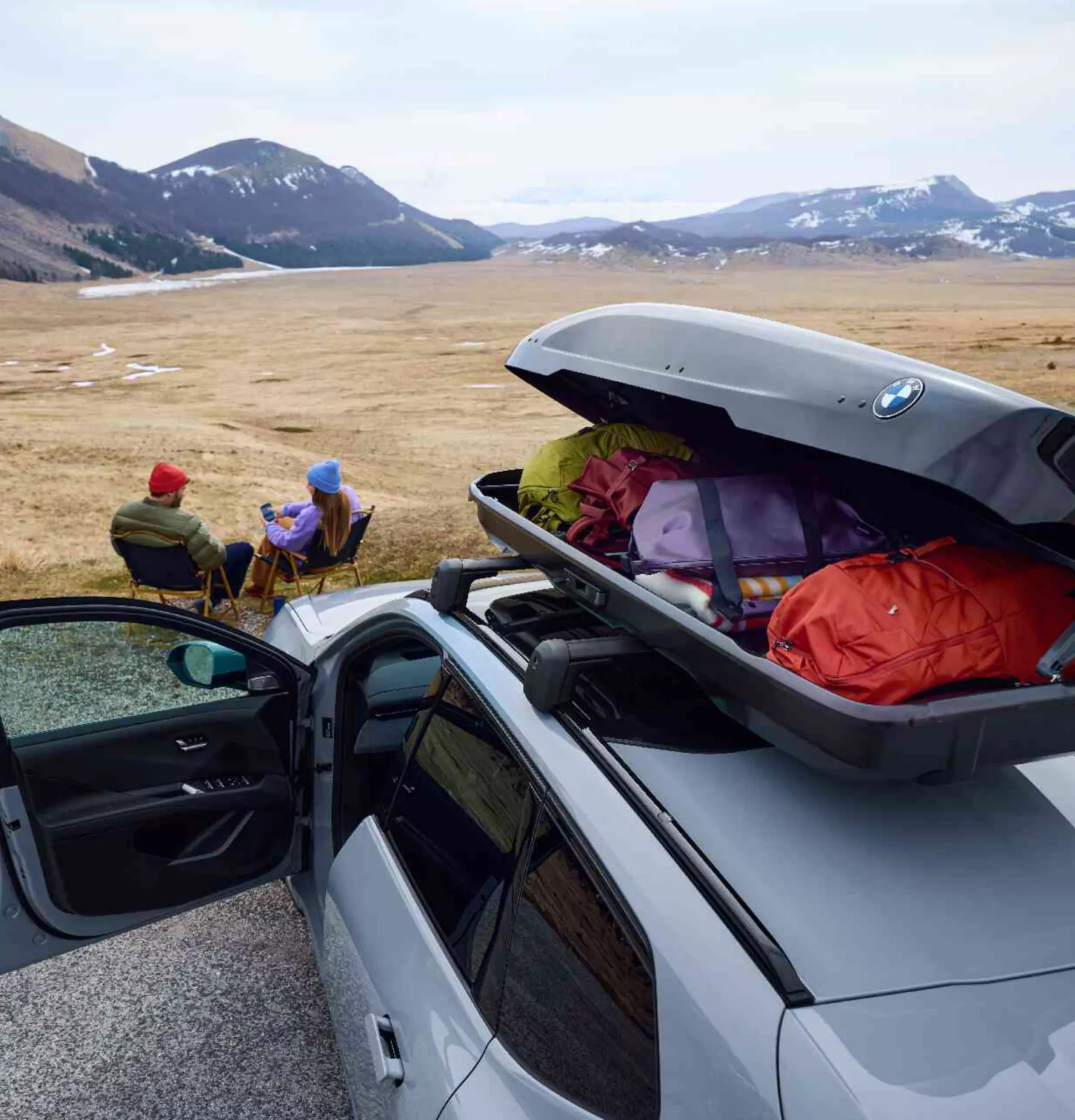 BMW iX3 roof box standing in front of the mountains
