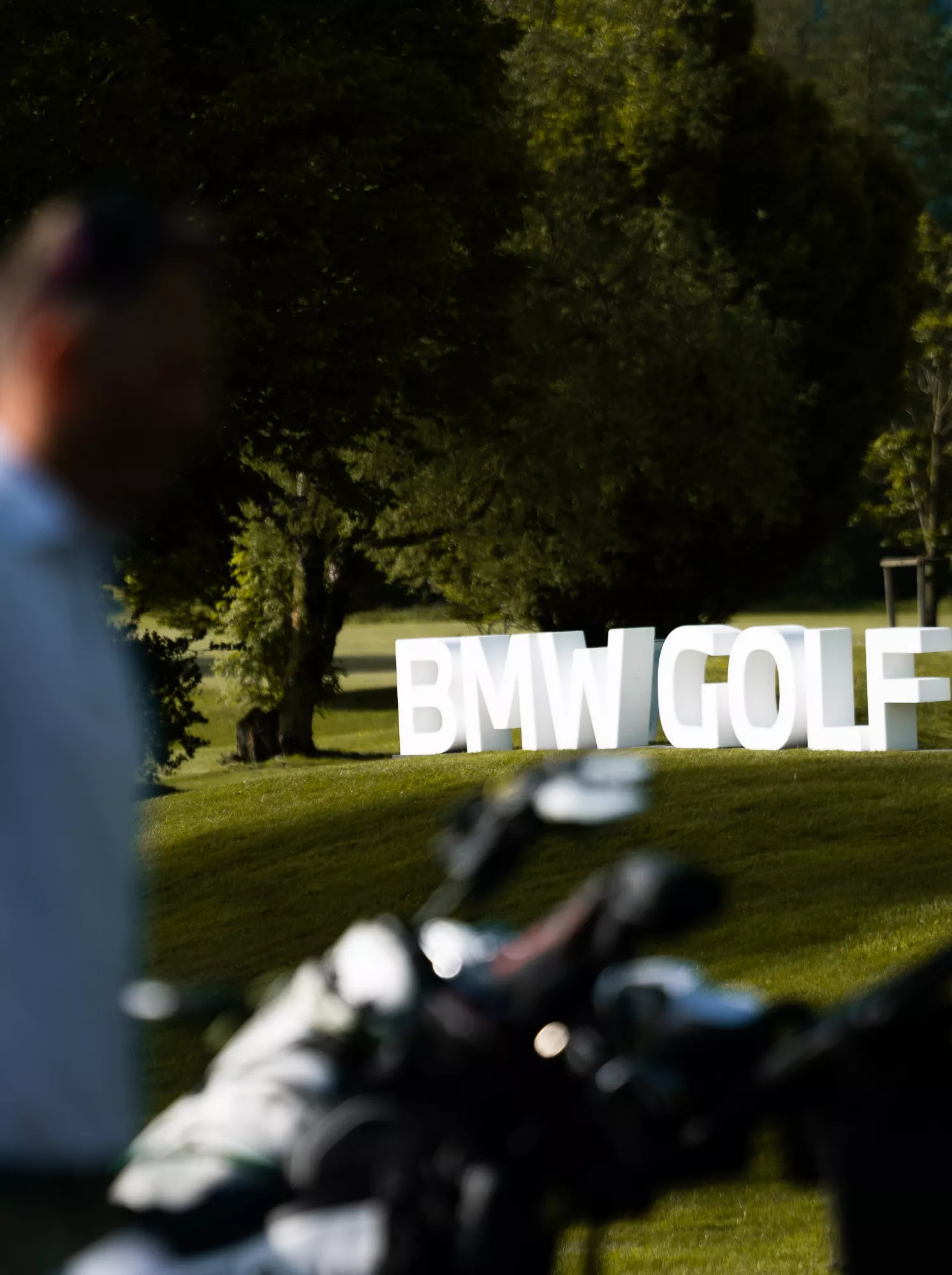 Golf course with BMW flag and golf balls
