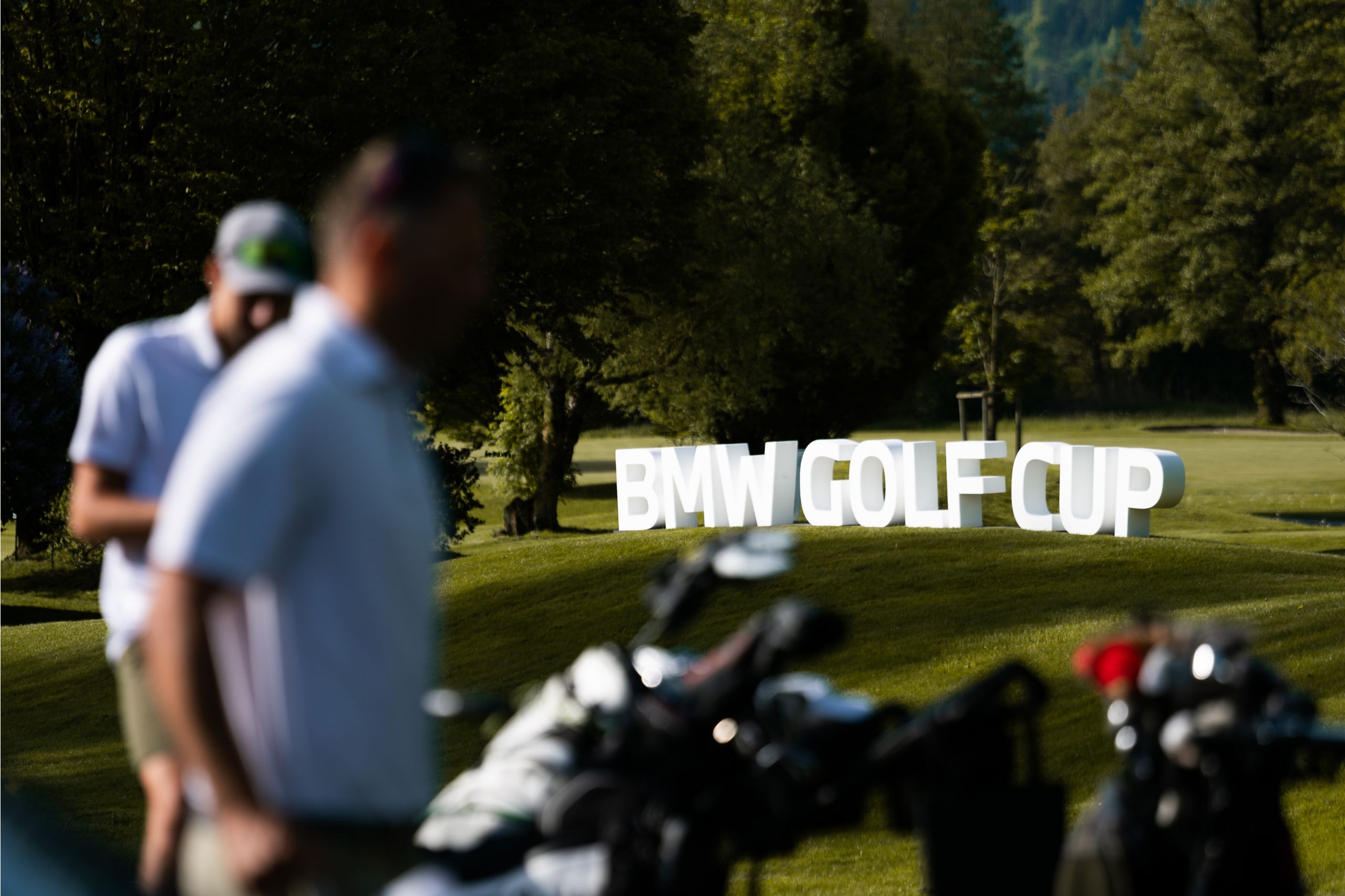 Golf course with BMW flag and golf balls