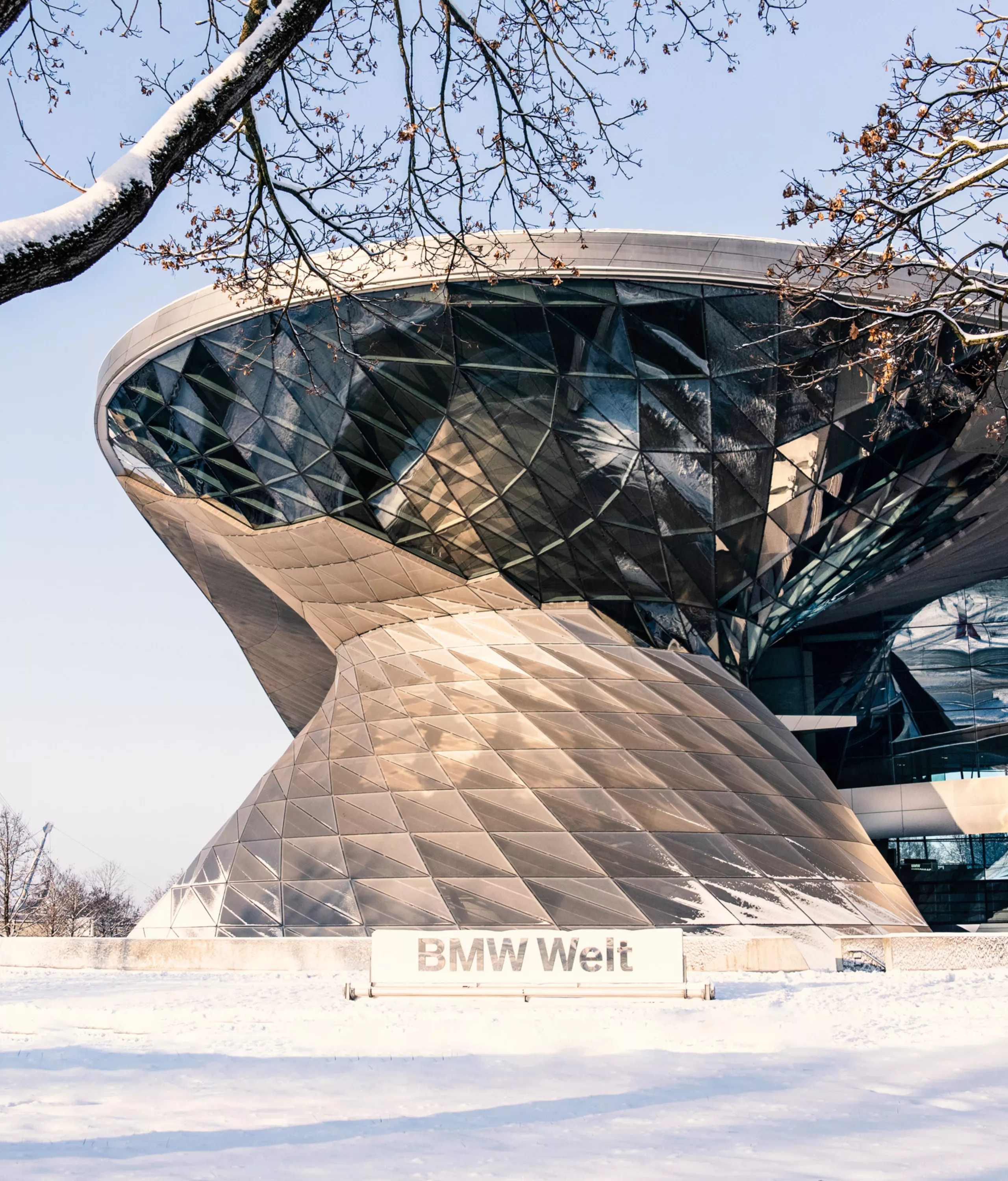 Exterior view of the Double Cone at BMW Welt, surrounded by a snowy landscape.
