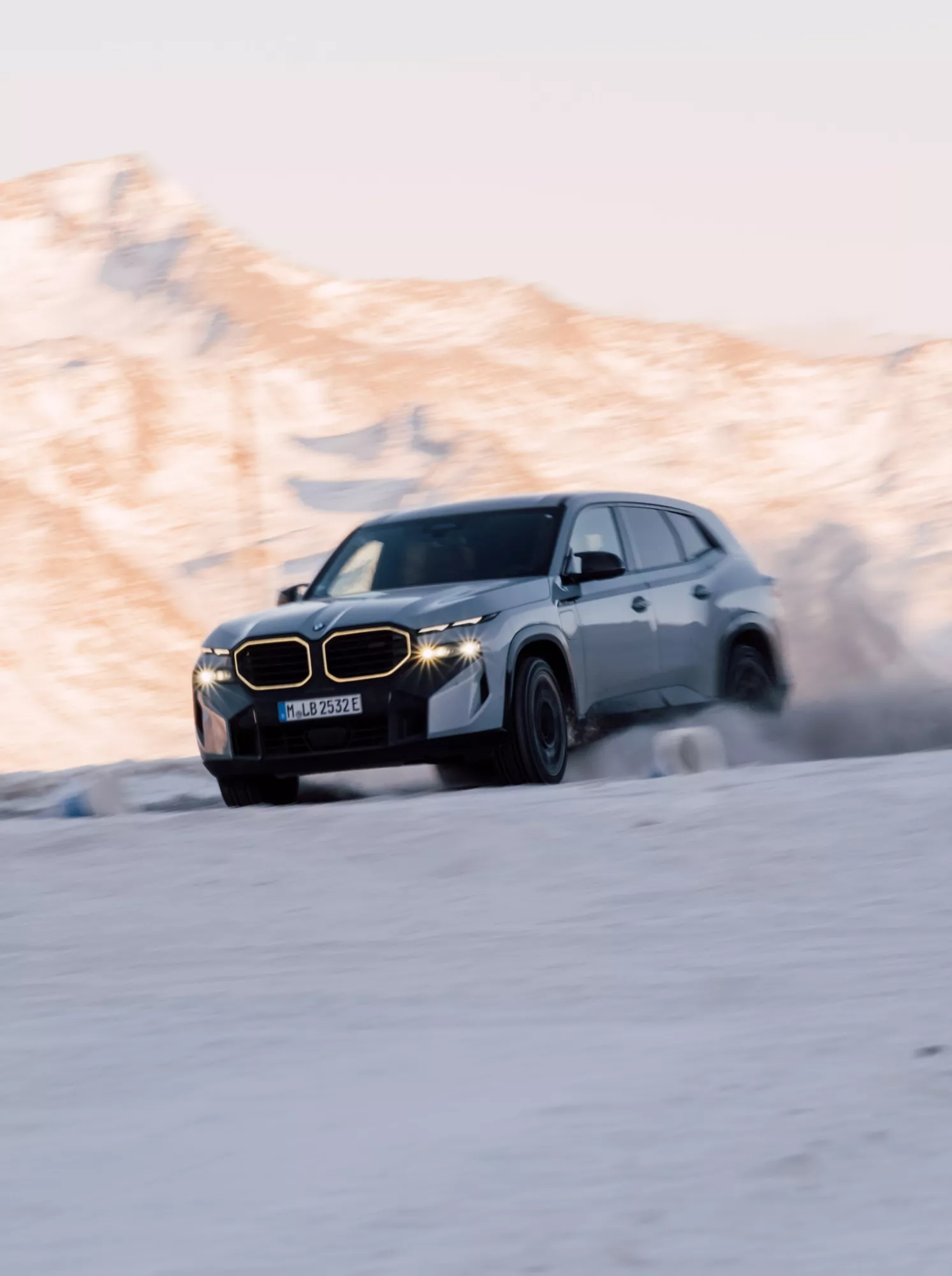 Grey sport car drifting on snowy terrain